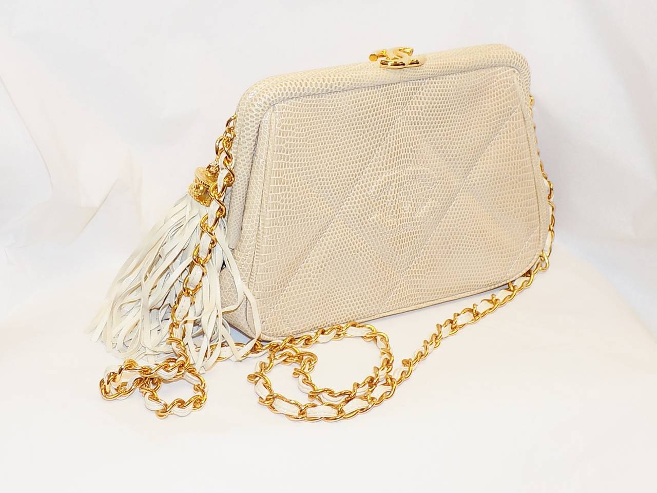 Beautiful vintage Chanel  lizard bag. Pristine condition  without any signs if wear. Looks completely new. Cafe au lait  color. Leather lining with one zip pocket . Top snap closure cc logo in gold tone. . Chain with leather that could be removed