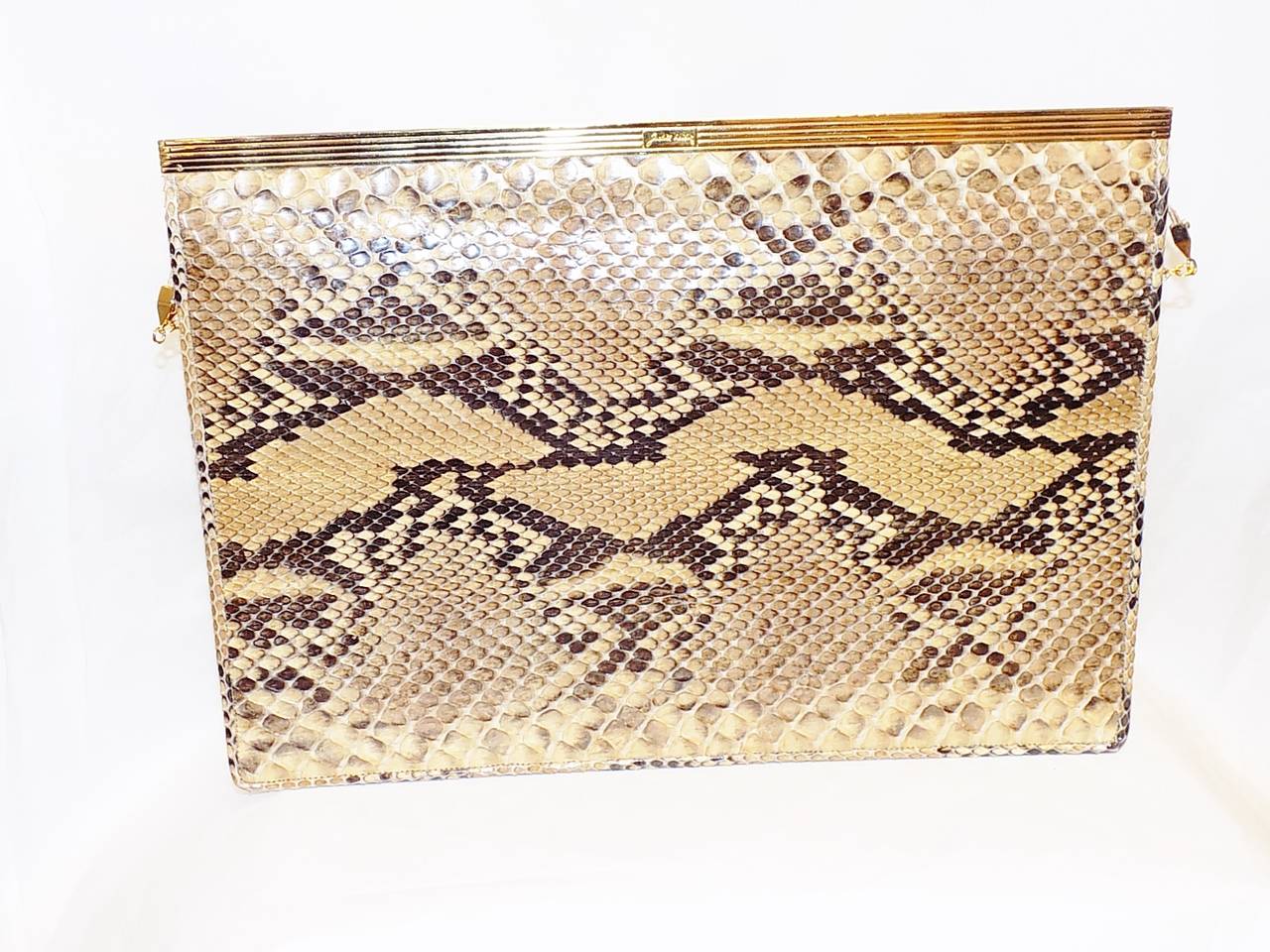 Original stunning  Judith Leiber design !. Large  genuine python  lined in tan fabric. Sleek and modern design with gold tone top frame. . . Front flap  opens the bag that  give you so much room yet  looks very  slim and elegant. Extra snap closure