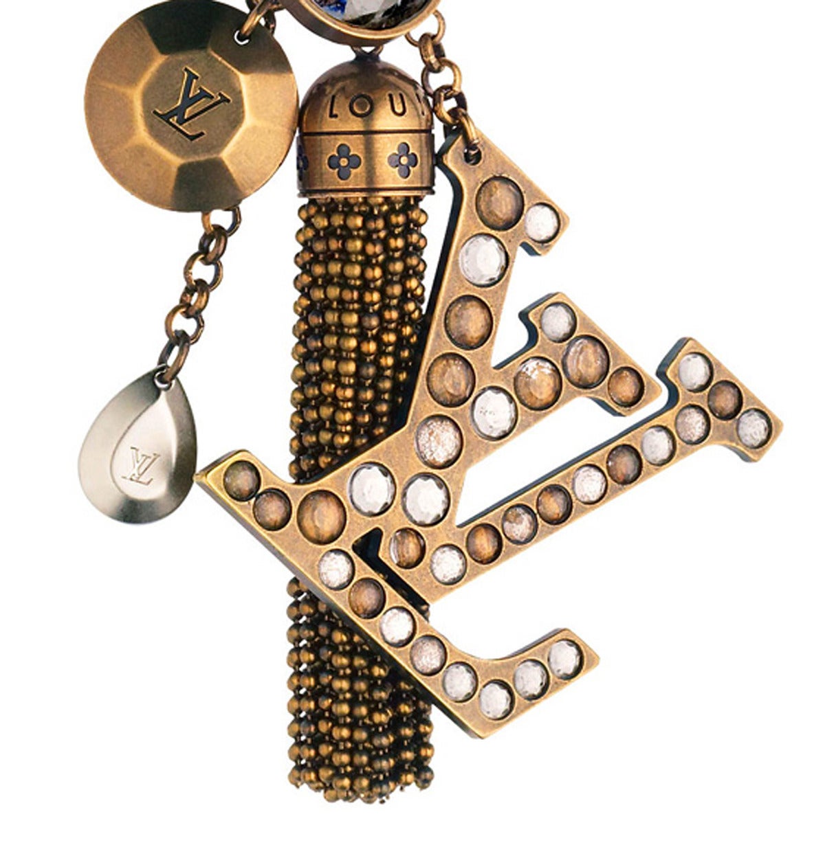 Beautiful Louis Vuitton  bag charm/key ring that coincides with this season’s obvious trend, the tassle. Caprice Key Ring is an eye catching bag charm as it features an antique gold-finish brass tassle, strassed LV logo and Crystallized™ Swarovski
