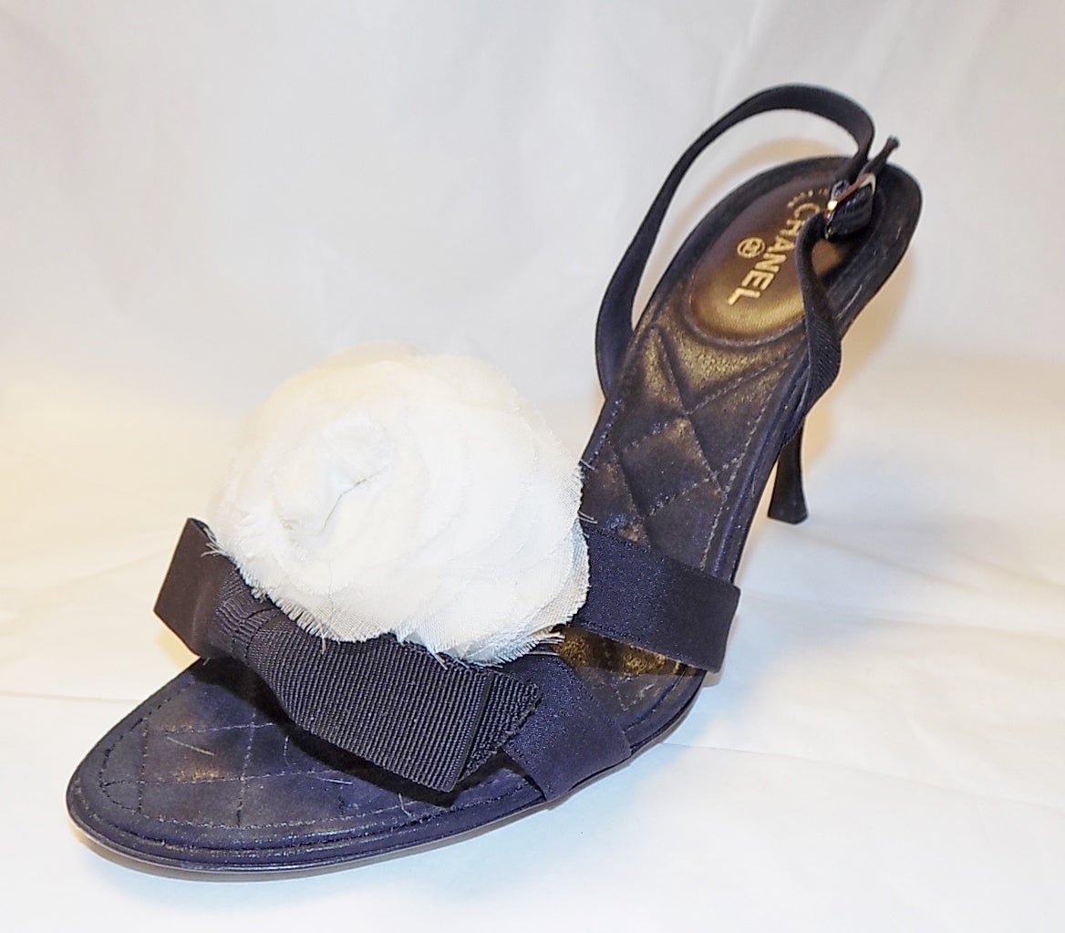Chanel Black Fabric Camellia Bow Heels. Quilted  leather  sole and heel . White silk organza  camellia. Size 39.5 heel 3.5 inches. worn once in excellent condition
