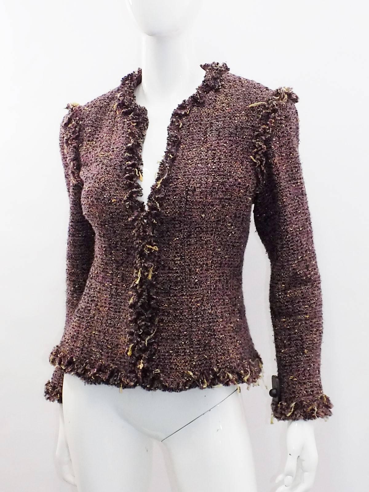 Beautiful cropped Chanel catwalk Boucle fringed trim jacket Collection Fall 2003. Dark plum , blue and yellow with just a touch of gold thread. Hook and eye concealed front closure. Silk camellia print lining. Size 42
Bust 38