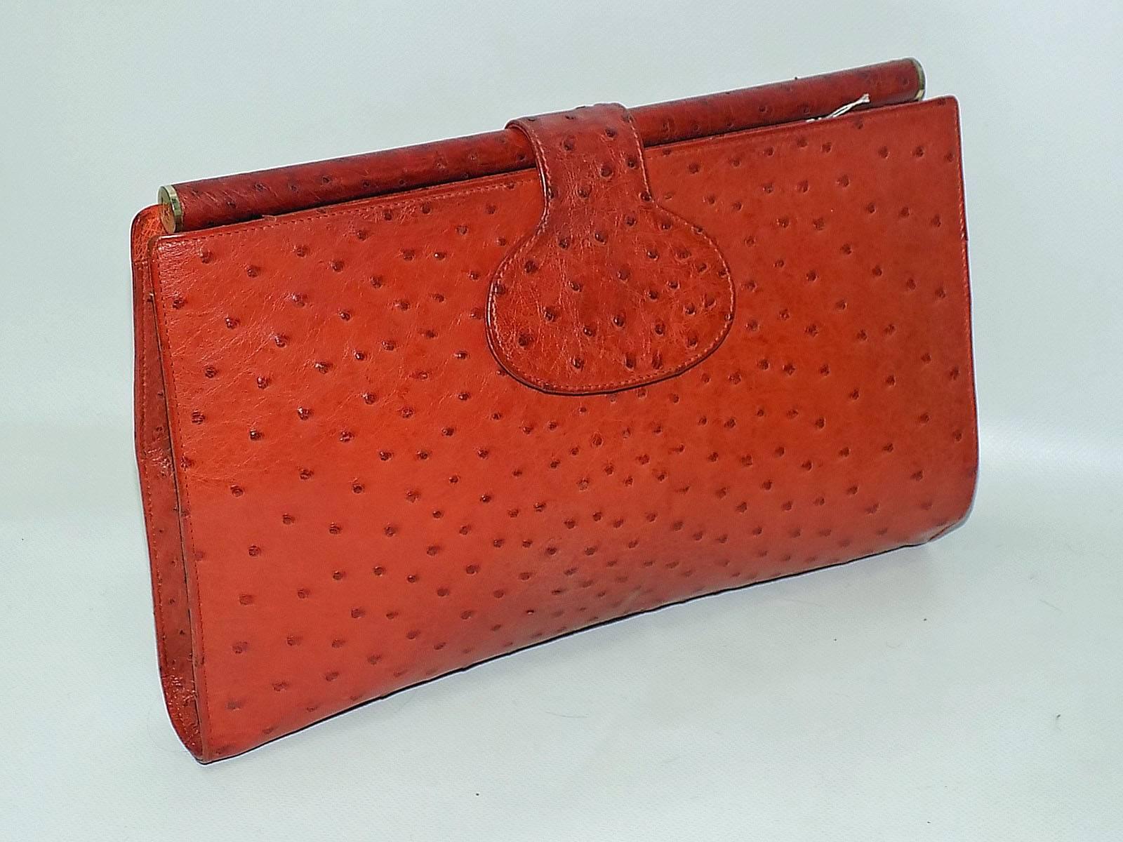 Rich cognac color genuine ostrich  Fendi Clutch bag.  Pristine condition. Like new! Hard round top frame with Fendi  engraved logo on the side,  Flip top snap closure. Ivory leather lining.  Two zip pockets  and one small pocket inside with  ostrich