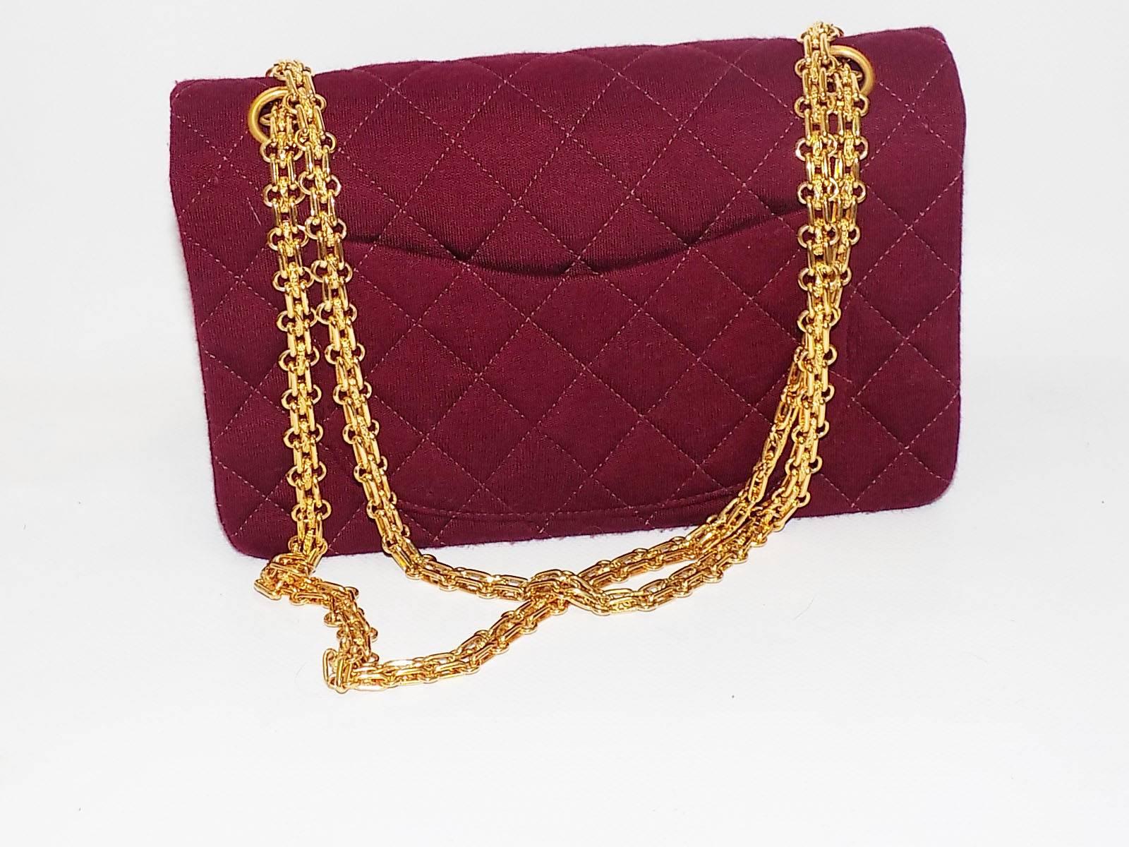 This iconic Chanel 2.55 will be the next classic you'll want to add to your collection! Its burgundy jersey exterior is designed with a quilted stitch and gold tone hardware. Must-have for any Chanel gal, this item, also referred to as the classic