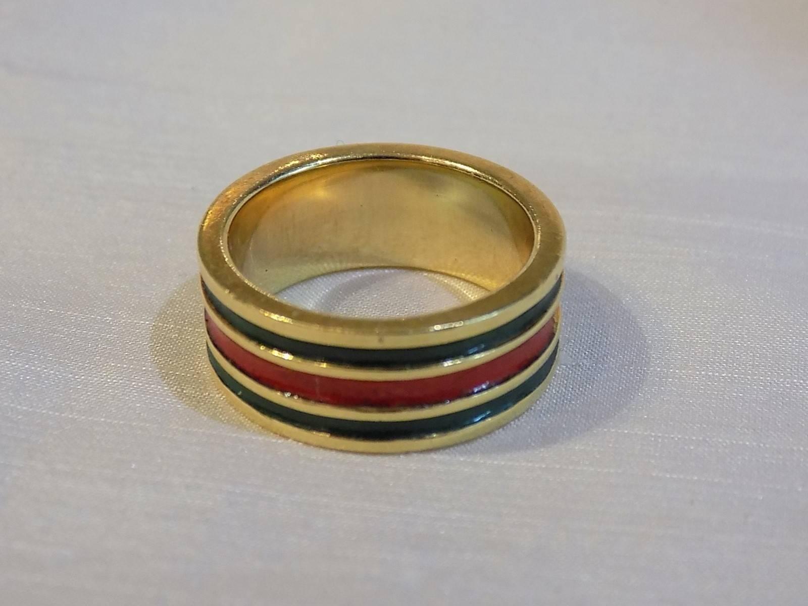 Super Rare and so beautiful Gucci Vintage red and green Enamel 18K solid Gold Band Ring Circa 1970.  Size 6  . Signed Gucci.  Very heavy  solid 18K ring. 
Fabulous Find for Gucci Cillector