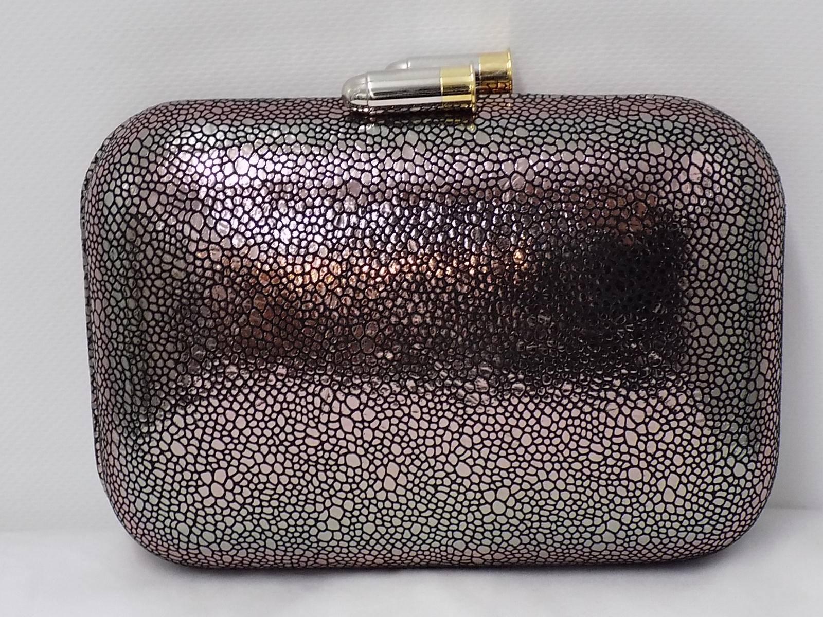 Founded by Fiona Kotur Marin in 2004, KOTUR is about bridging the gap between modern technique and traditional craftsmanship.

Cute reflective  Minaudiere -evening clutch with style, glamour & a touch of whimsy.Shiny two bullets as a top snap.