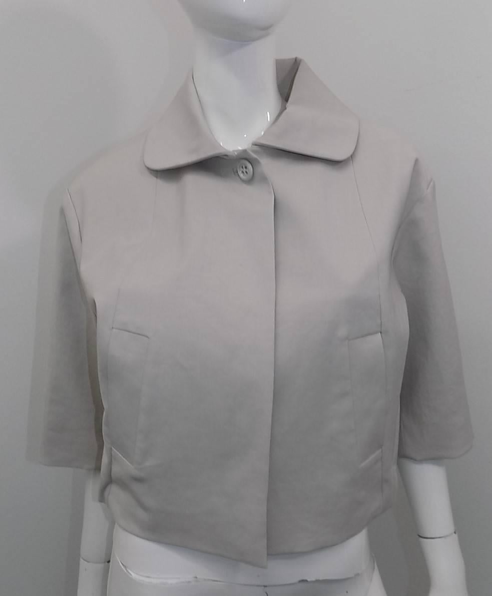 Beautiful brand new Chloe Summer rain jacket.  Lite sand color / lite gray.  Concealed front buttons,  Rushed half waist and wide 3/4 sleeves. Side pockets.  Cotton treated for rain. half lined with backing of wool an linen .
Made in France. Size 