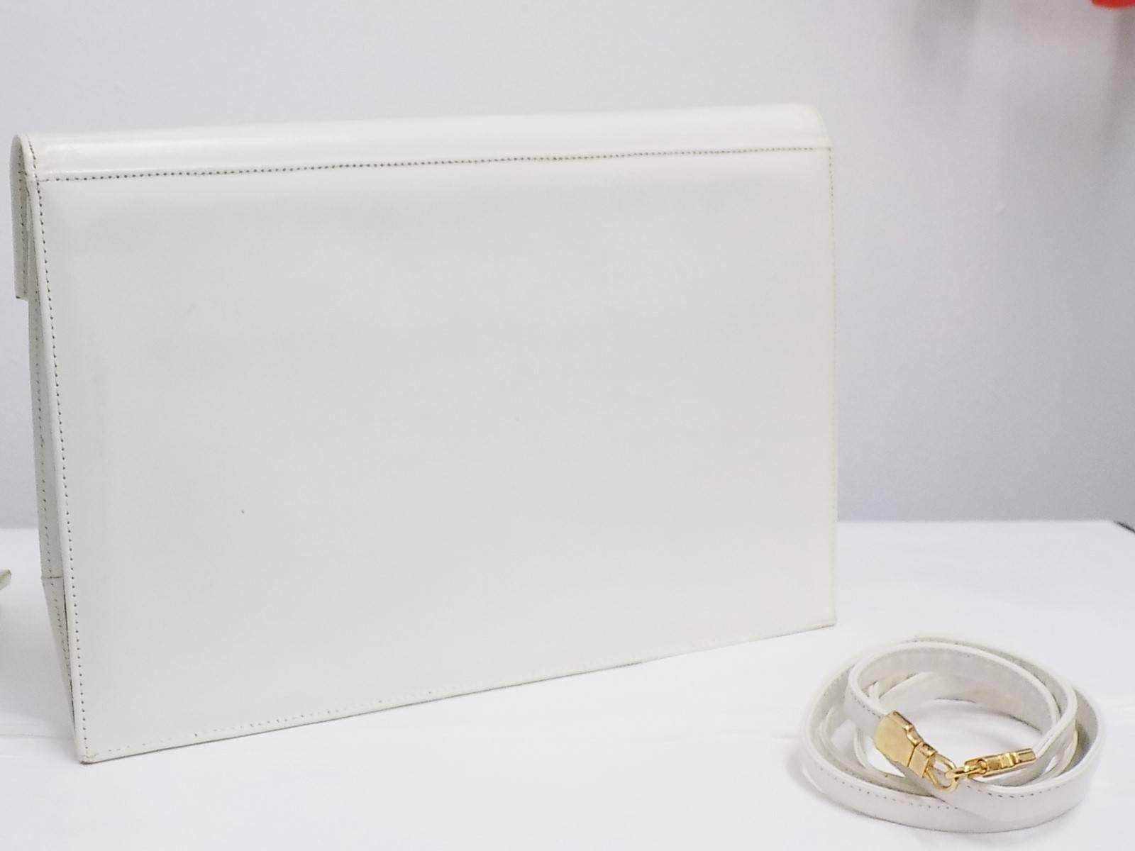 Beautiful  piece of American designer history. STUART WEITZMAN Art deco  vintage envelope clutch bag with shoulder strap . Well structured with clear window front and multi colors leather. Very clean and in great condition. Only signs of the age is