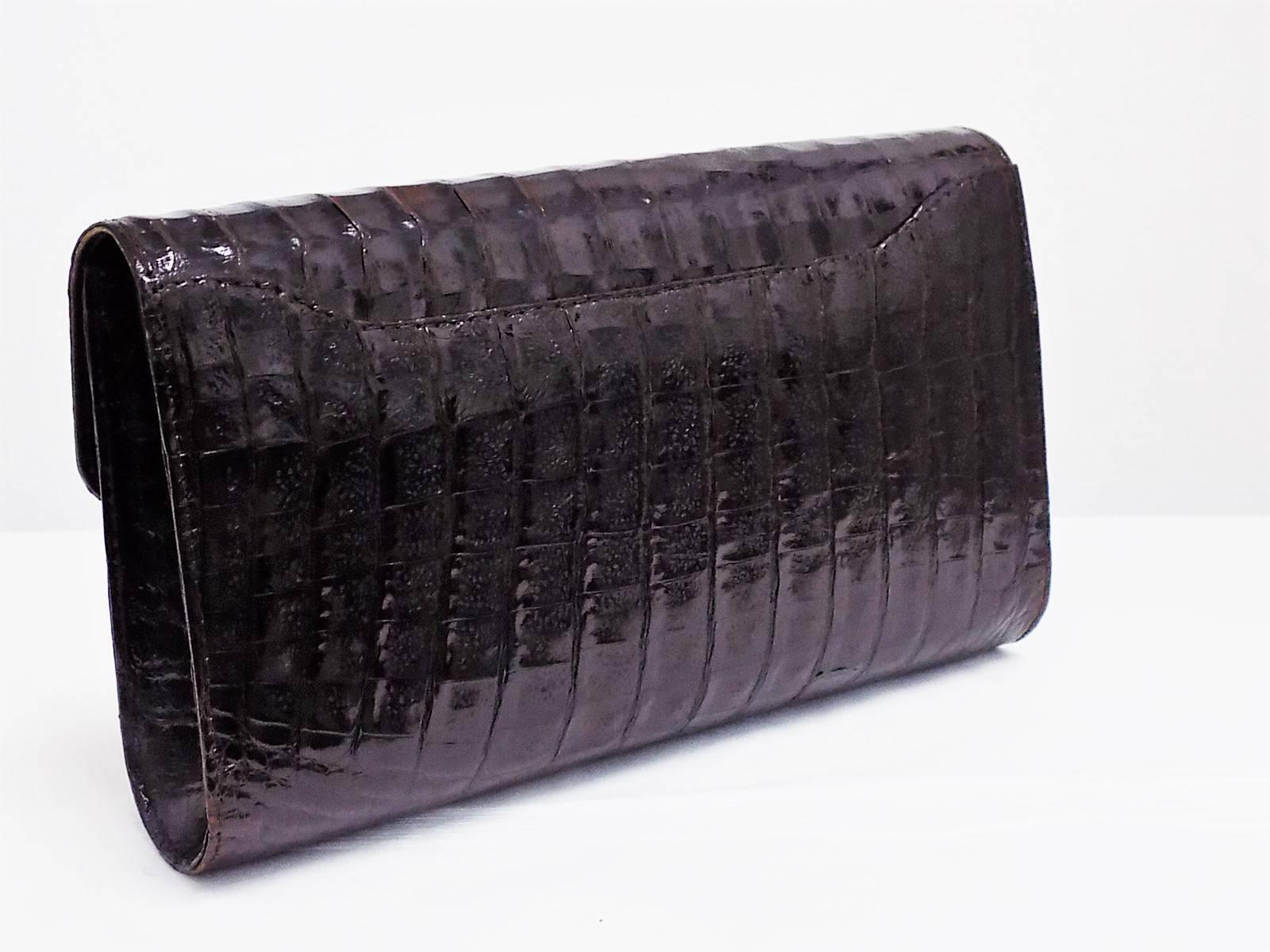 Amazing Vintage Valentino Garavani Chocolate Brown  Alligator  Clutch/ Shoulder Bag . Pristine condition . Beautiful luster and perfect shape!. Removable shoulder strap . Small Valentino logo  at the front. Magnetic snap flap closure. Leather lined