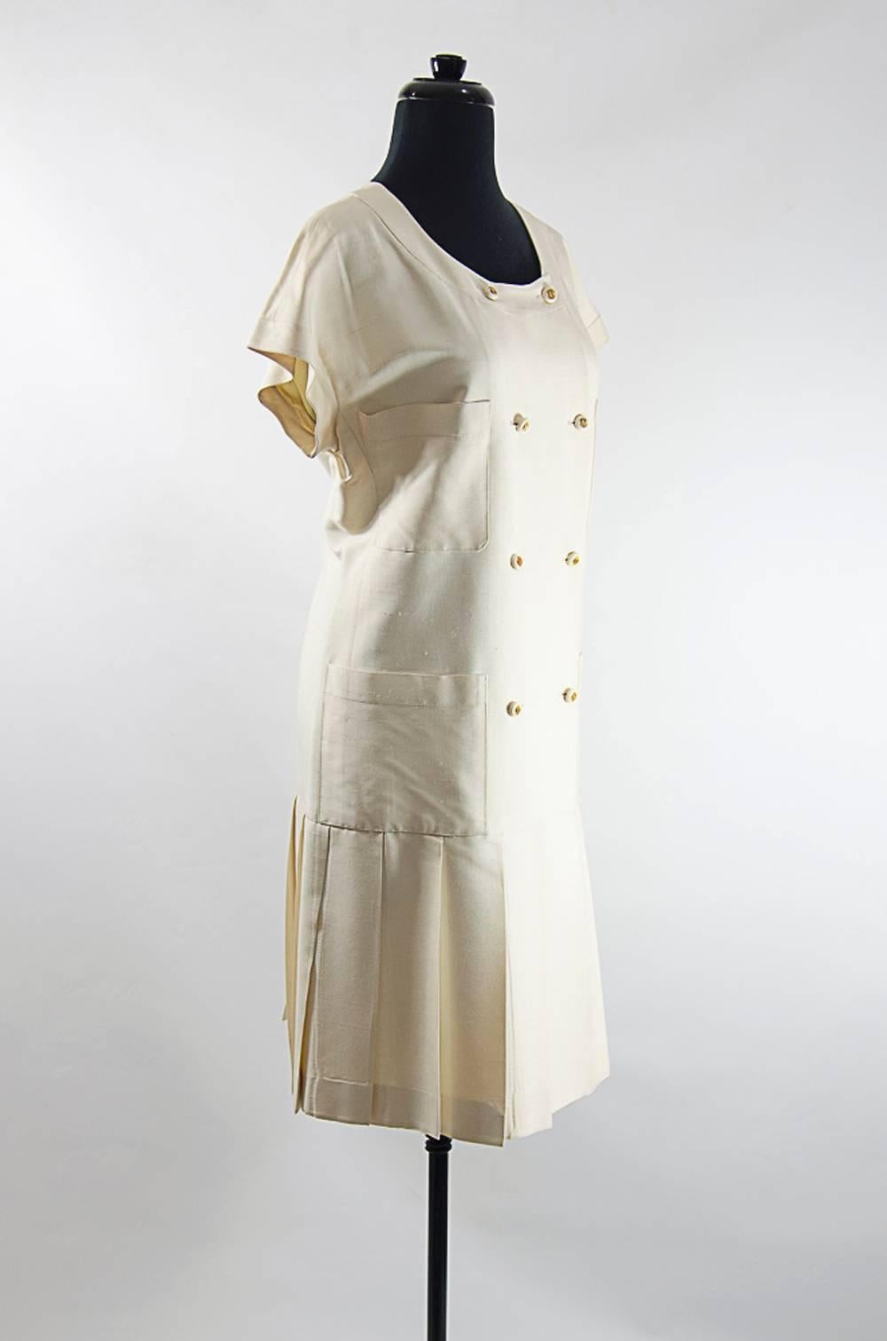 Raw silk Chanel dress. Double breasted front closure with ivory buttons gold cc logo in the middle.Kimono sleeves. Pleated bottom. Shift style. . Excellent condition. Size 44
