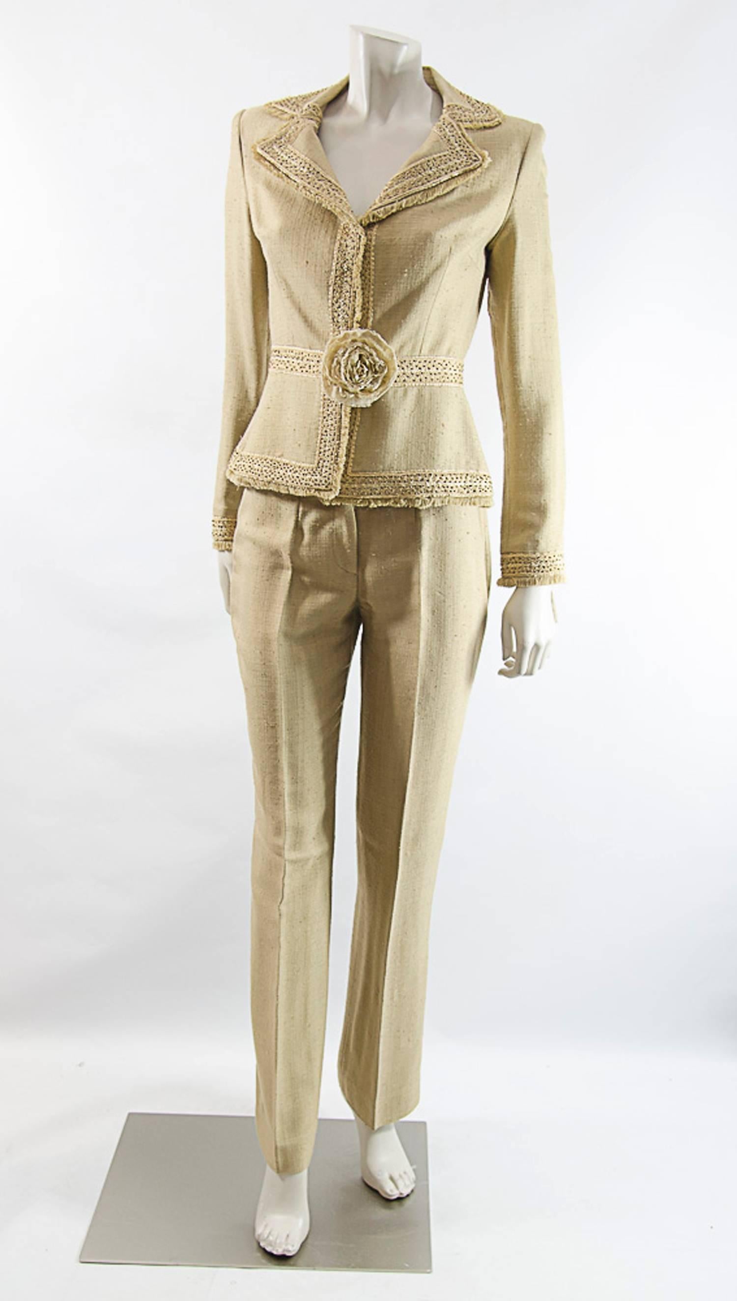 Naeem Khan has established a loyal celebrity following---Jennifer Lopez, Eva Longoria, Beyonce, and Queen Noor of Jordan. He created most elegant pieces of clothing as this silk pant suit embellished with hand beaded trim, hidden closure anf