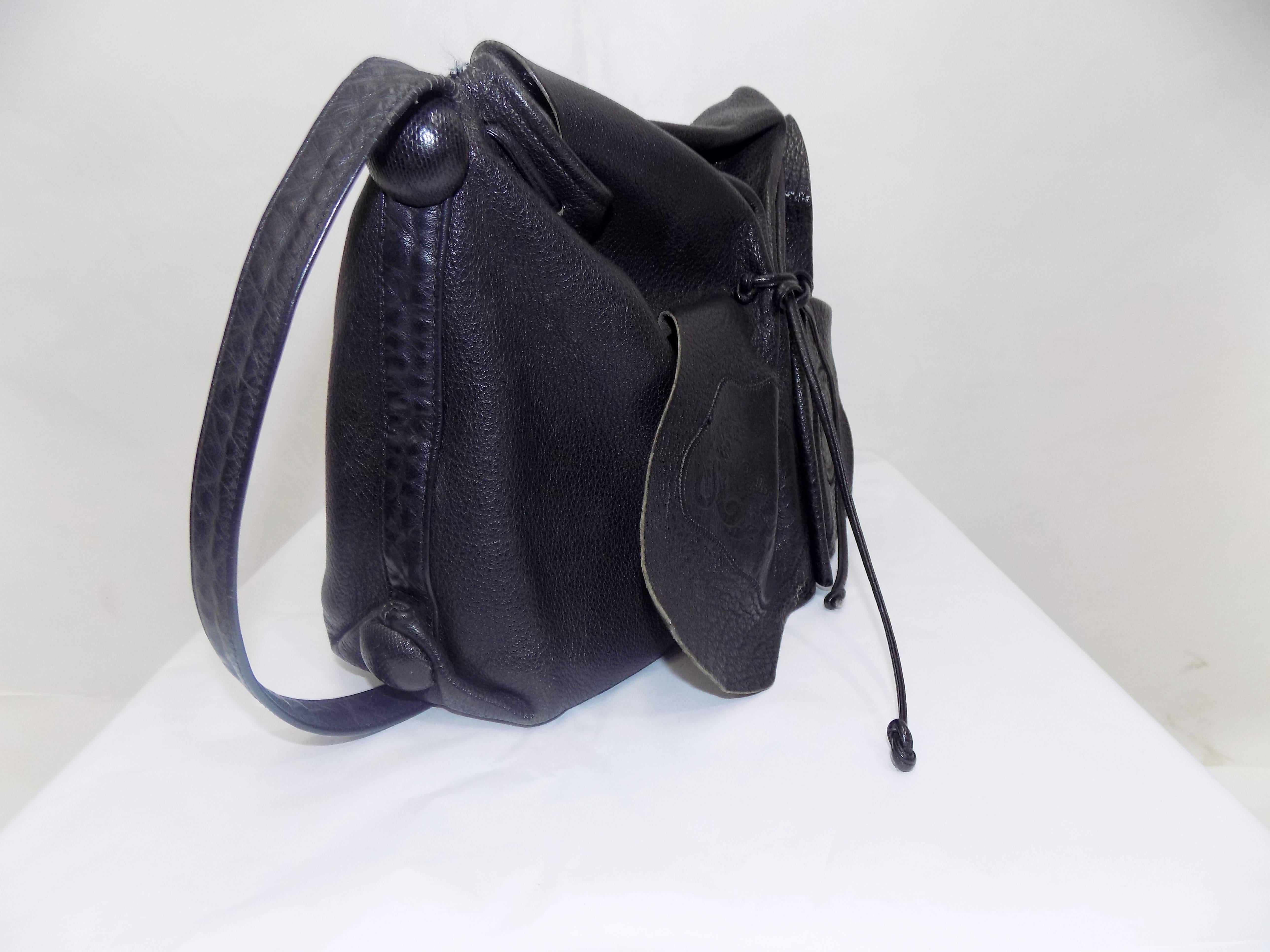 Carlos Falchi's signature black textured calfskin adjustable drawstring cross-body bag.Large size  measures 11