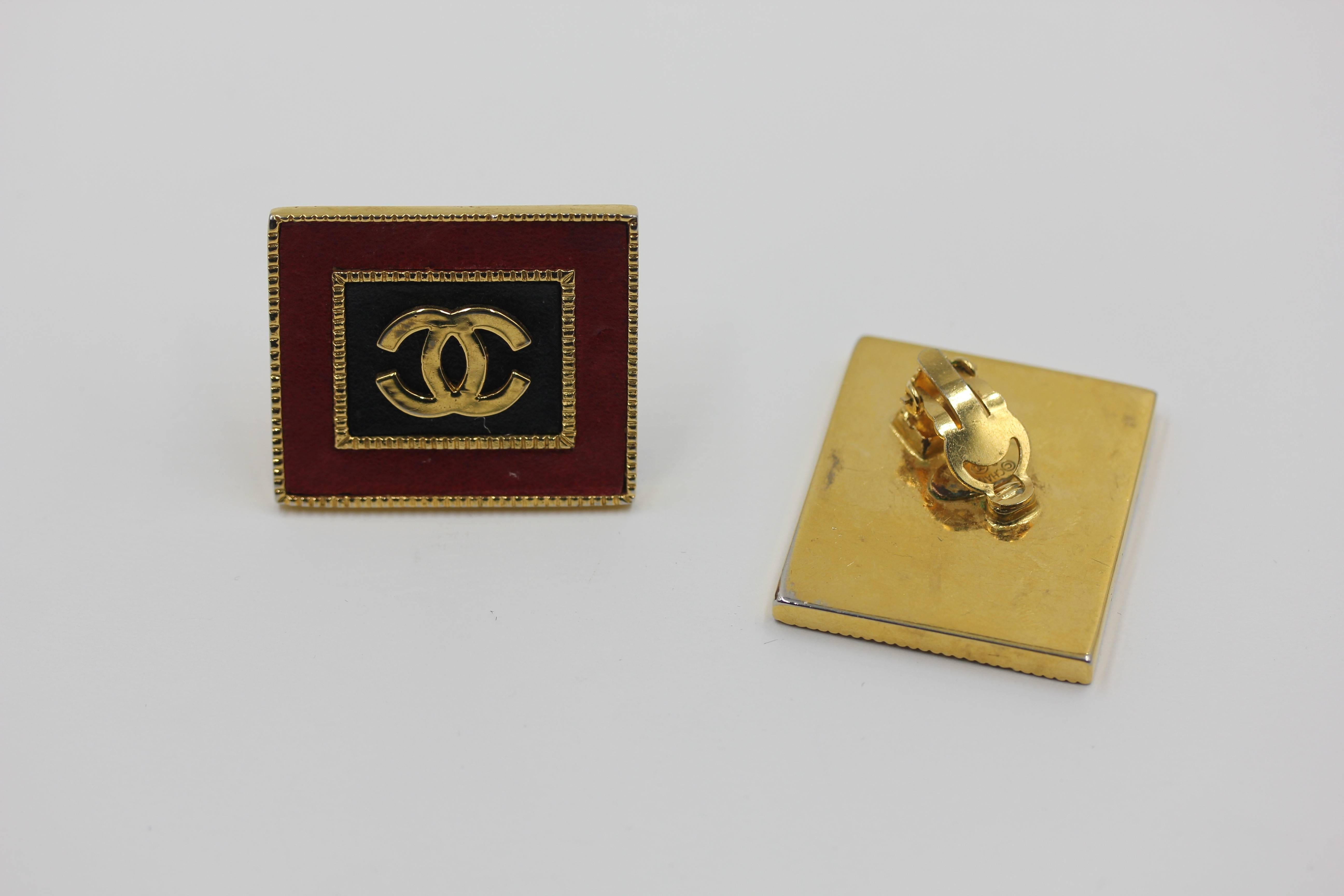 VINTAGE RARE Chanel Gold Tone Red Black Leather 'CC' Square Clip On Earrings . Vintage Chanel earrings from Collection 26, circa 1989. This very rare design emulates the exaggerated style of the 80's. . Square shape sits at an angle on the ear lobe.