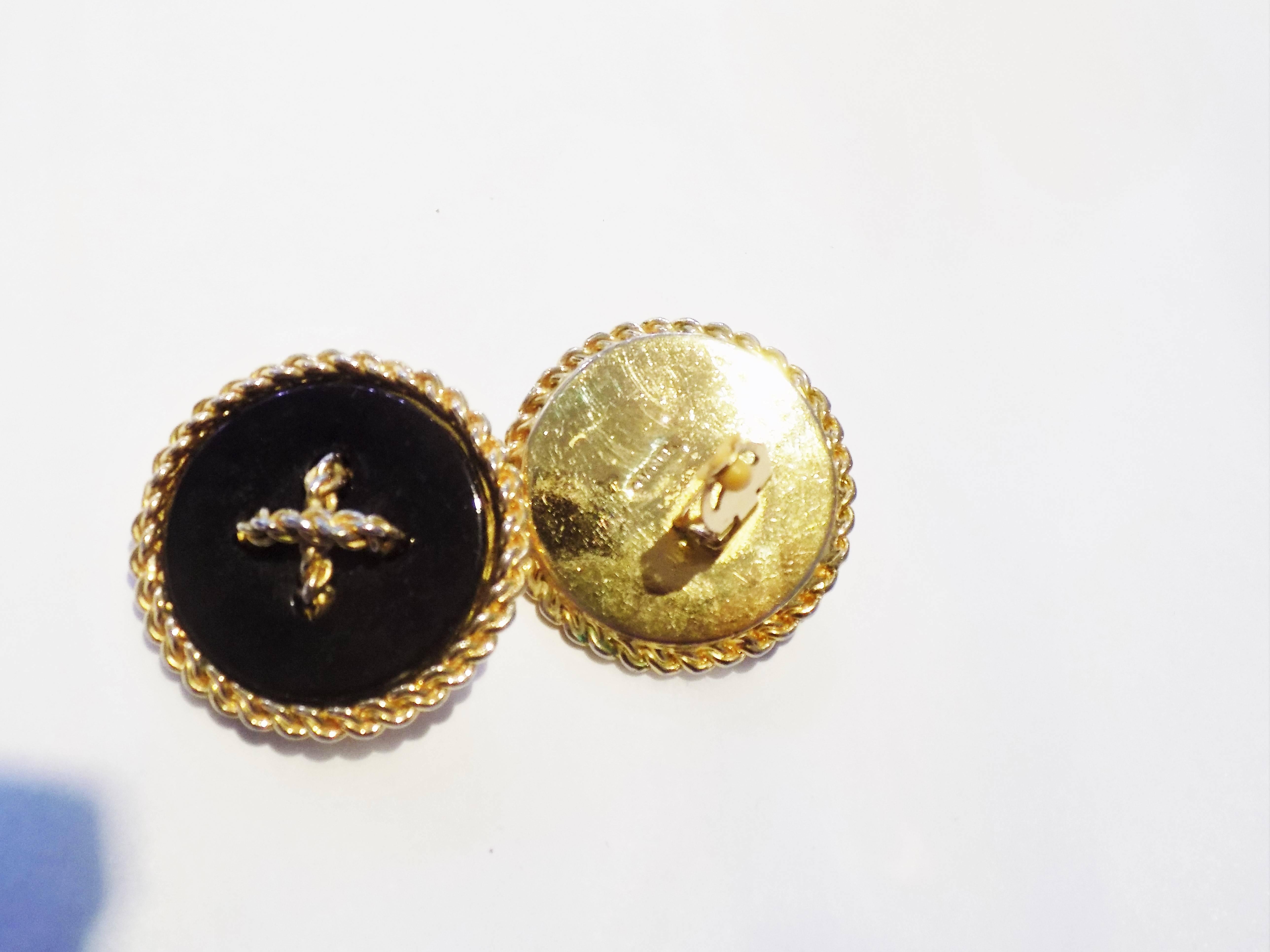 Rare and fabulous Chanel actual Buttons earrings . Gold tone and black clip on. Excellent condition. Early 1980's Earrings are 1 1/2 in diameter