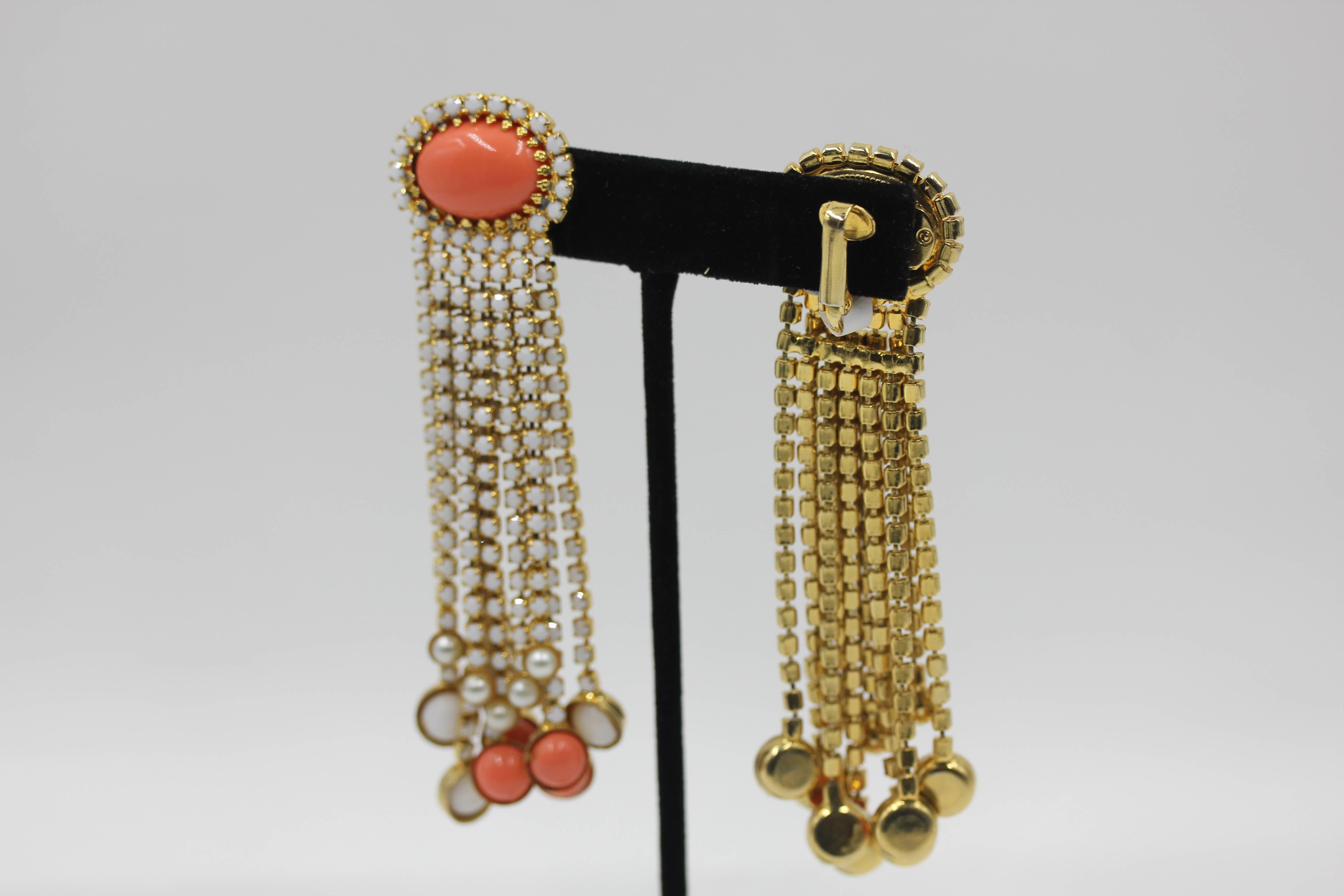 Pristine Condition KJL Kenneth J Lane Vintage Long  Dangle Earrings .Faux Pearl,coral resin , and white strass, Oval ear piece with 12 gold metal strass set fringes. fabulous piece. Ear piece is 1 inch by 3/4
