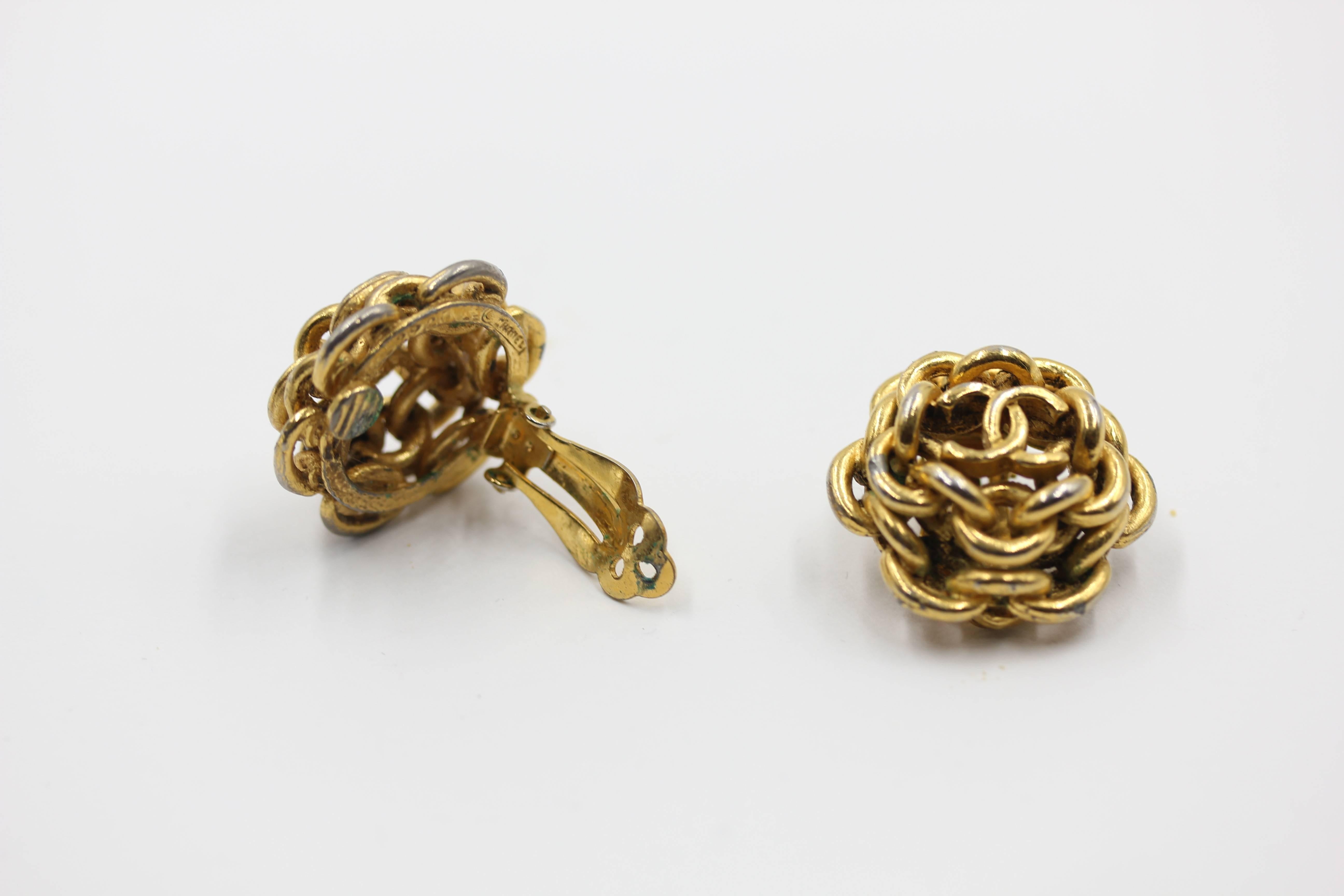 Circa 1978 solid chain in gold tone Chanel Earrings with CC logo in the middle. Signed. Clip On  Has some   Slight discoloration on the gold but still beautiful earrings . Size  slightly over 1