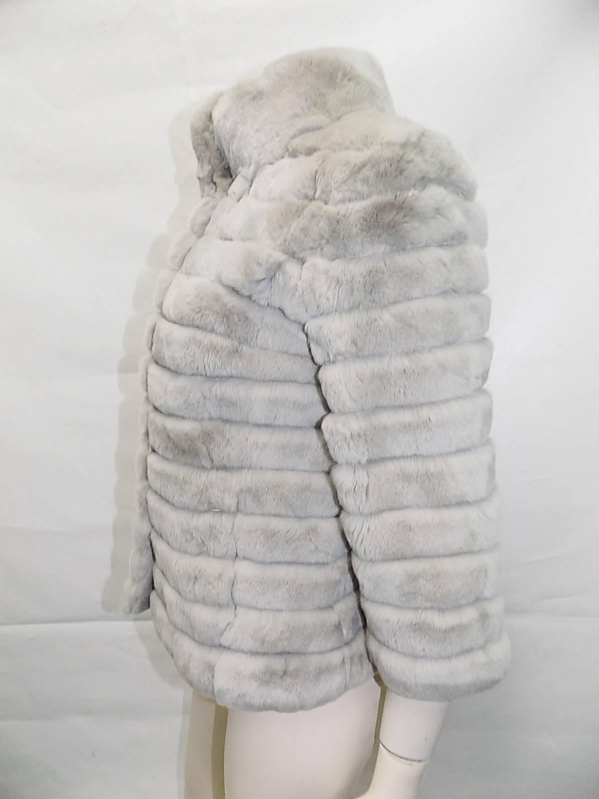 Beautiful new Rex rabbit dove grey short jacket with 3/4 sleeves. Very chic design with high collar and 34/ sleeves. Perfect with long gloves, jeans and boots. Luxurious Rex Rabbit . Chinchilla like. Bust 40