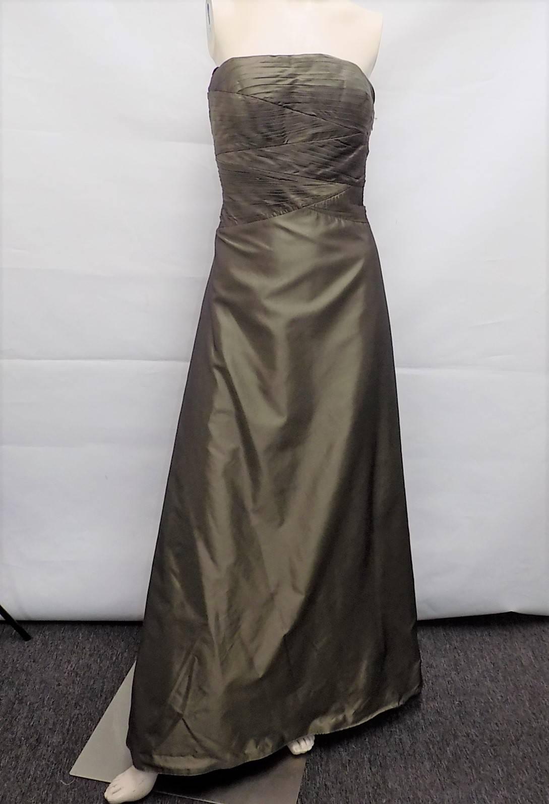 Gorgeous A line corset gown .Metallic silk taffeta. Pleated bodice  Bone reinforced . Underskirt sewn in for that full look. Jacket is all beaded silk organza with closure at the collar. Mint condition. States size 10. 
Gown bust  38" waist