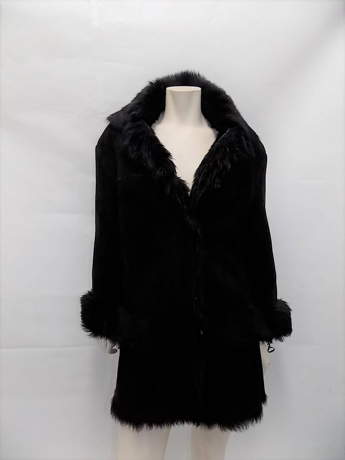 Pristine condition fabulous long hair Gucci black shearling. Perfect length. Coat is light in weight but extremely warm. Features  canceled from buttons closure, two  pockets, high collar and cuffs. Size Italian 40 US 4 . Pristine condition. 