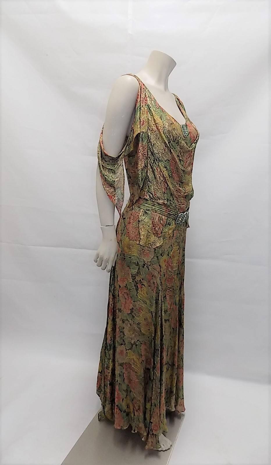 Incredibly beautiful silk metallic brocade gown. Floral print. Amazing design. Gown features  hooked sleeves that could be tied at the front  or let loose as shown on the photo, long tails hooked at the back as a bustle straight or crossed and
