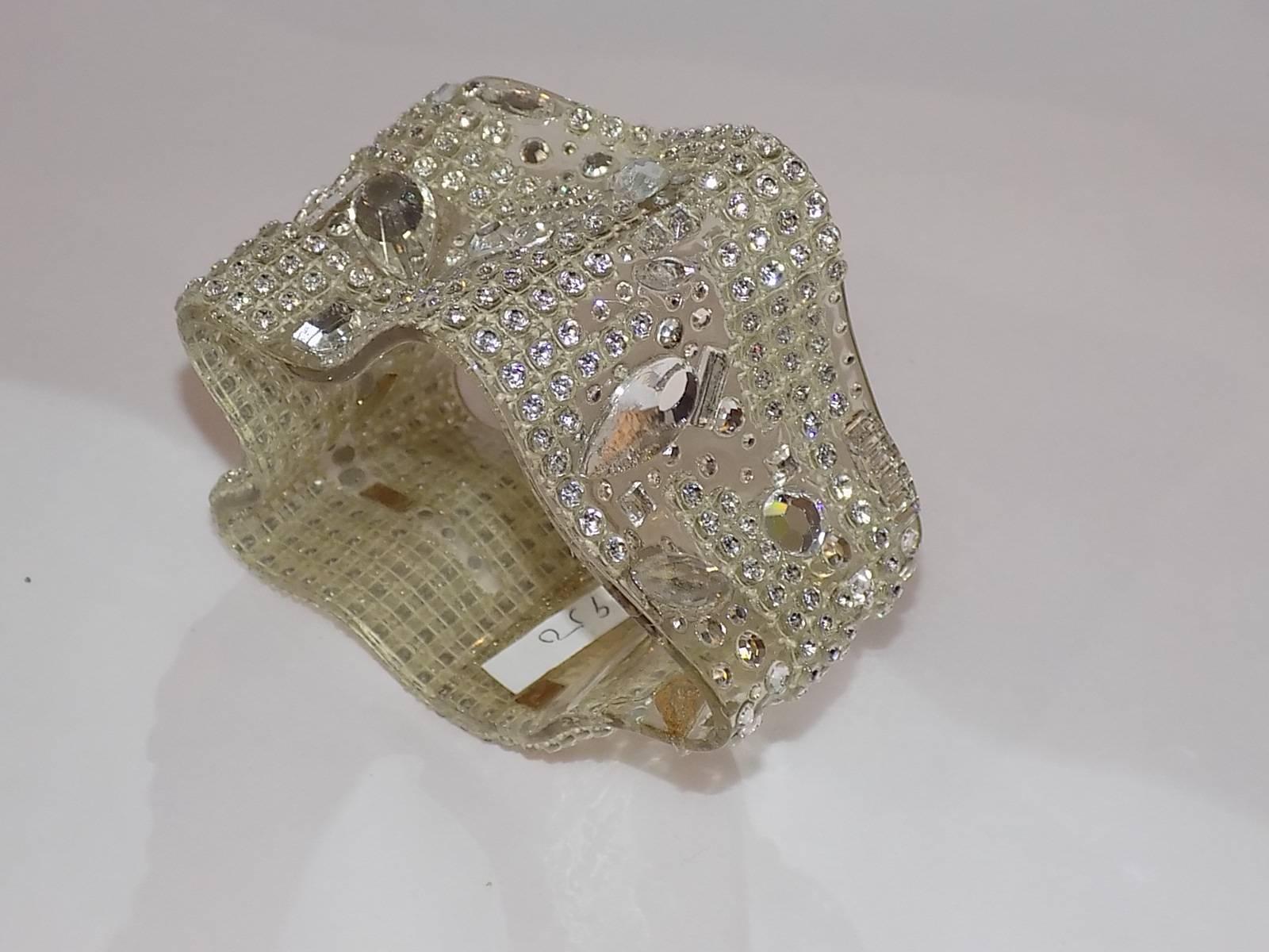 Wide  clear cuff Ribbon  bracelet created 1988 called "Citi Lights" Covered with antique and Swarovski crystals. 2.5" wide. Signed by artist and dated.