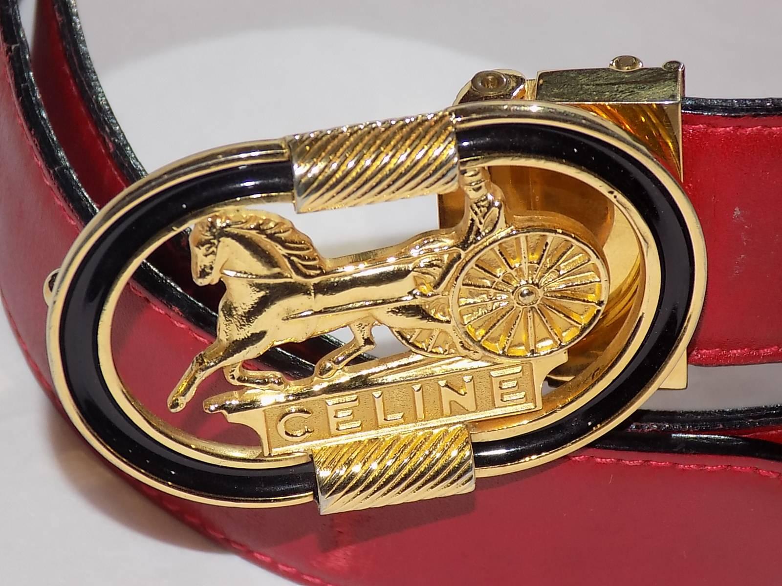 Fabulous Red Leather Celine Belt with gold tone oval buckle featuring Celine horse carriage logo. Black  Enamel painted rim. Pristine condition. Buckle is removable and belt strap could be replaced. 
Buckle size Approx : 2 1/4