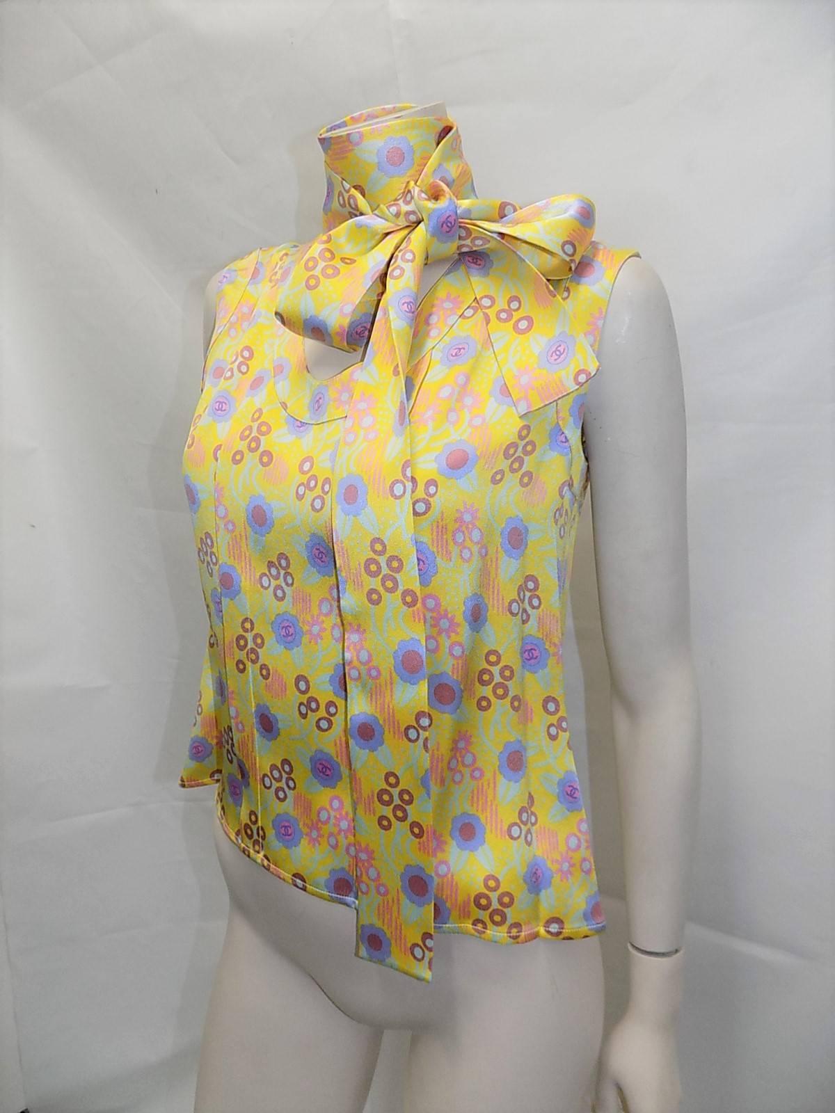 CHANEL Iconic Yellow Silk Print Blouse Absolutely Outstanding Everything we come to expect from Chanel. Elegant Classic Luxury. double CC's all over the top, the yellow color is just beautiful and has a delicate scoop neckline and buttons up the