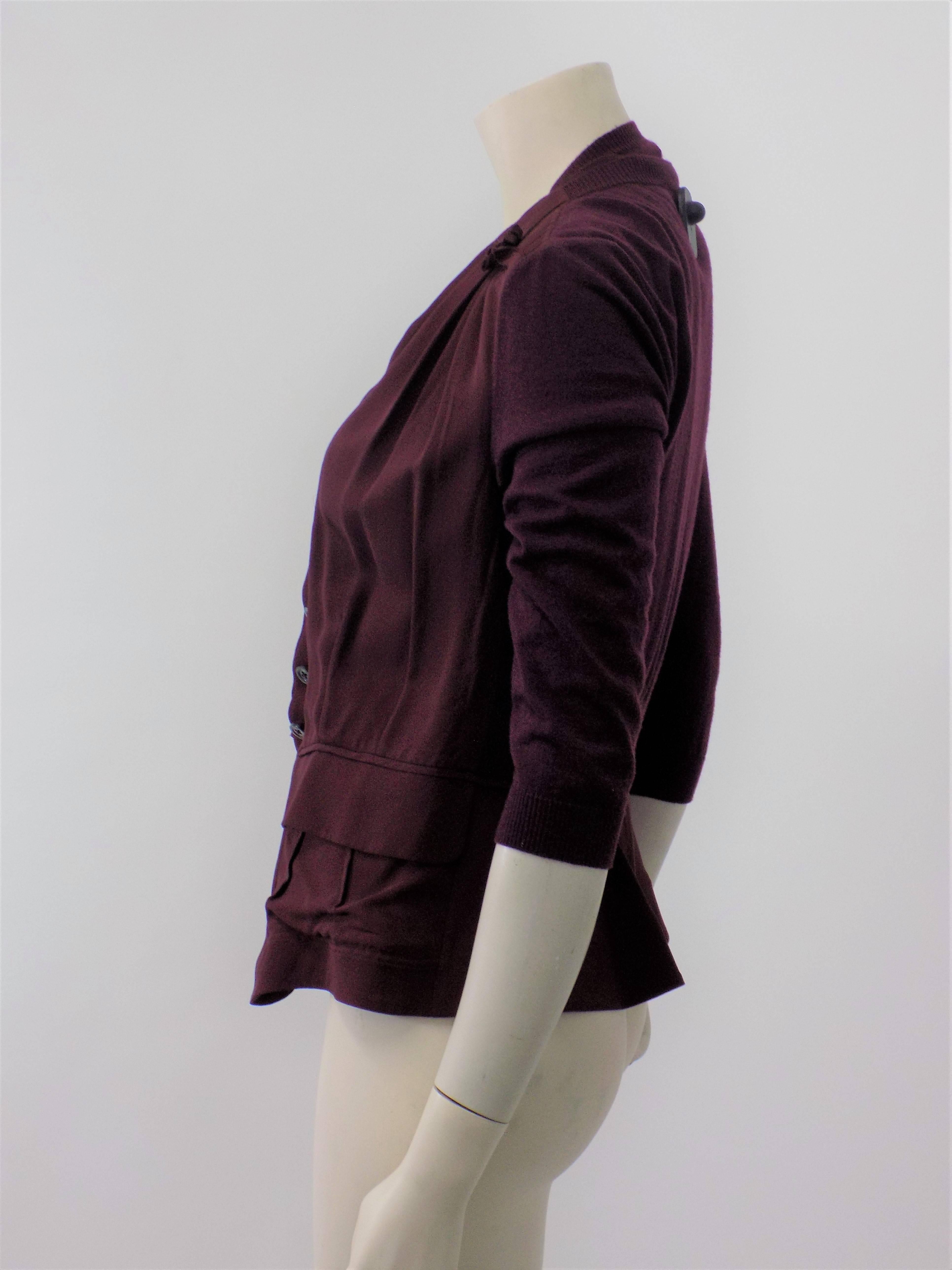 Never worn vintage Nina Ricci maroon cashmere and silk blend sleevless top with cardigan/ jacket . Combination of cashmere knit and sik featuring concieled front closure , two pockets  and long sleeves. Fabulous piece.. Size 40.  Bust 36