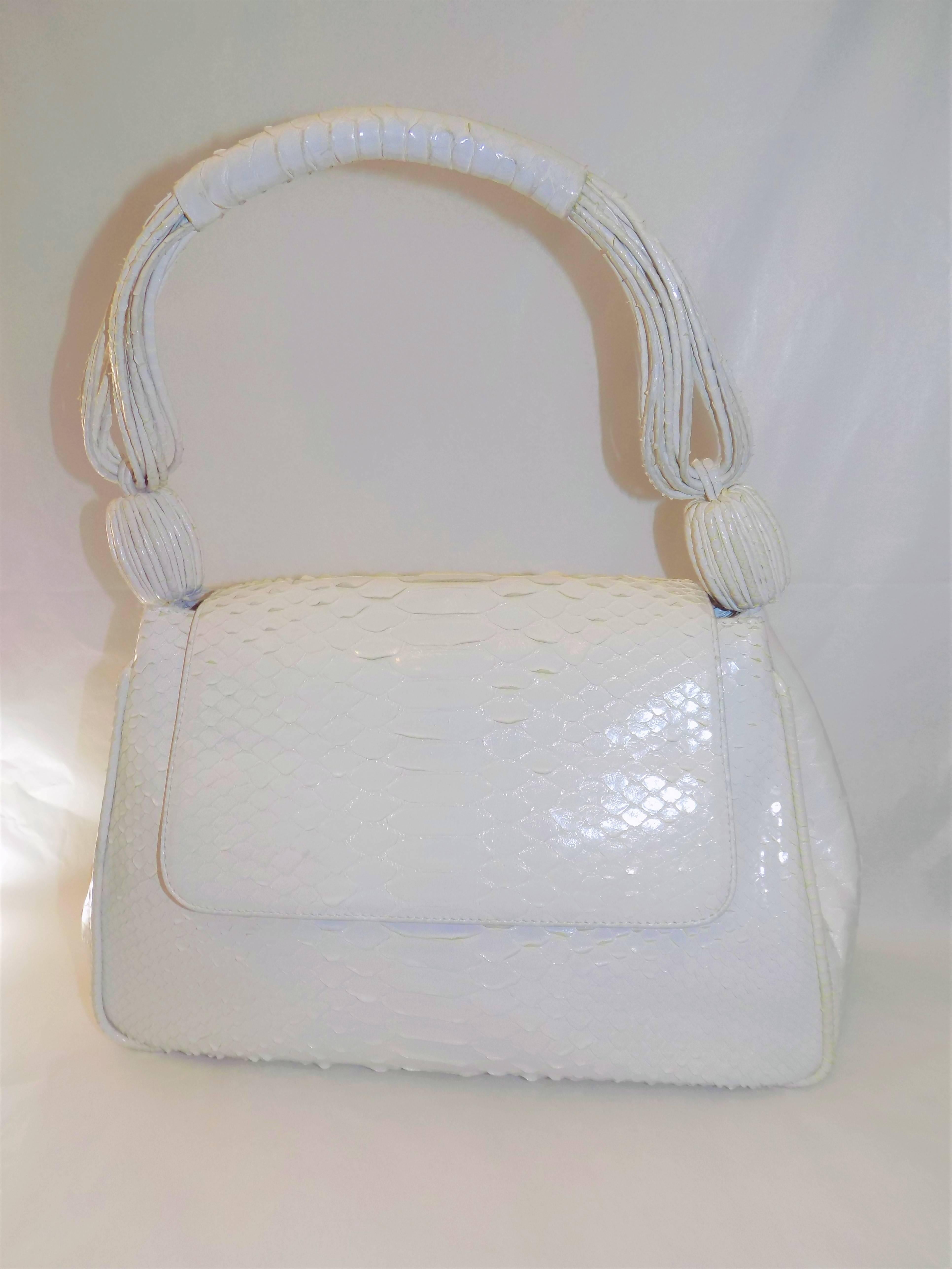 Never used fabulous hand bag by Nancy Gonzales.  Perfect summer bag. White python. Magnetic flap closure. Three compartments . Middle one is zip closure. Size has  two pocket- one for phone. Soft  suede lining. Shoulder strap is made of 8 python