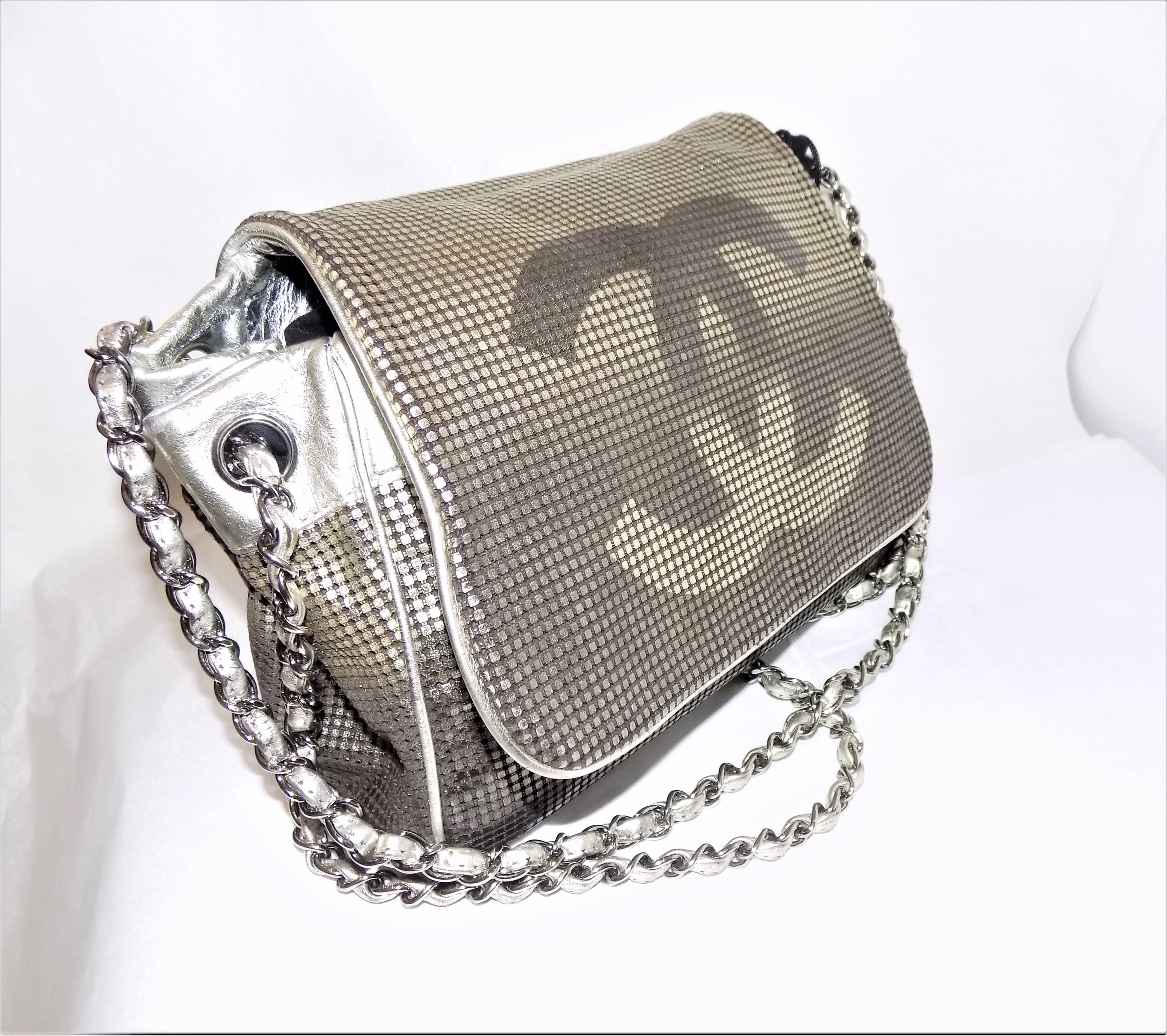 FABULOUS Chanel Hollywood CC Logo Silver Flap Purse Handbag 
Color: silver gradation  with silver hardware, 
100% Leather with large cc logo. Features Cell phone, Patch and Zip pockets
Length: 12
