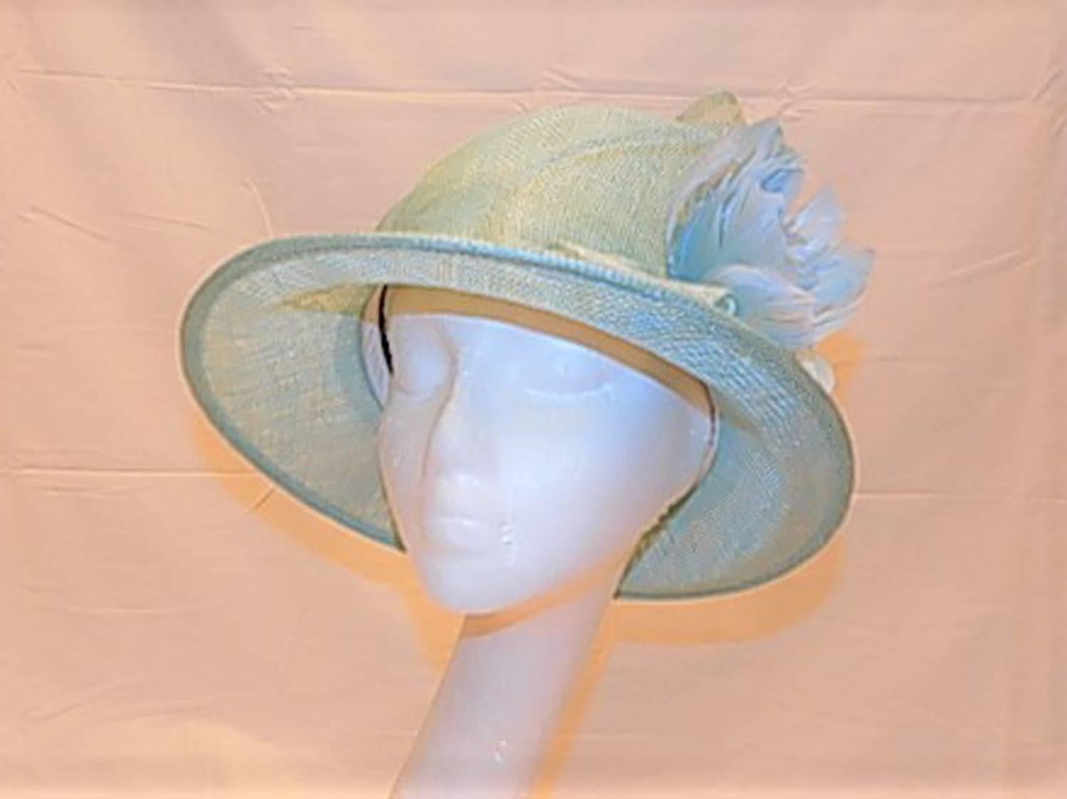 Spectacular baby blue summer hat. Beautiful design with foldings  , Clochete style . Silk flower and ultra fine horse hair side  details. One size fits all ,
Custom made by order from Couture Inc. House in Manhattan, NY