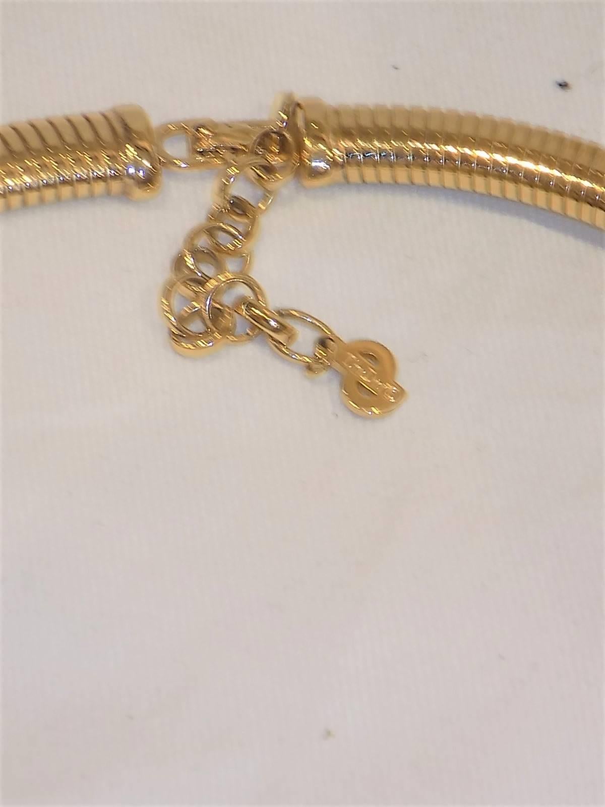Beautiful Vintage DIOR  gold tone and crystals  choker necklace. Snake  style movement design with crystal embellished middle part. Beautiful Art Deco piece. 
Signed. Pristine condition like new. 