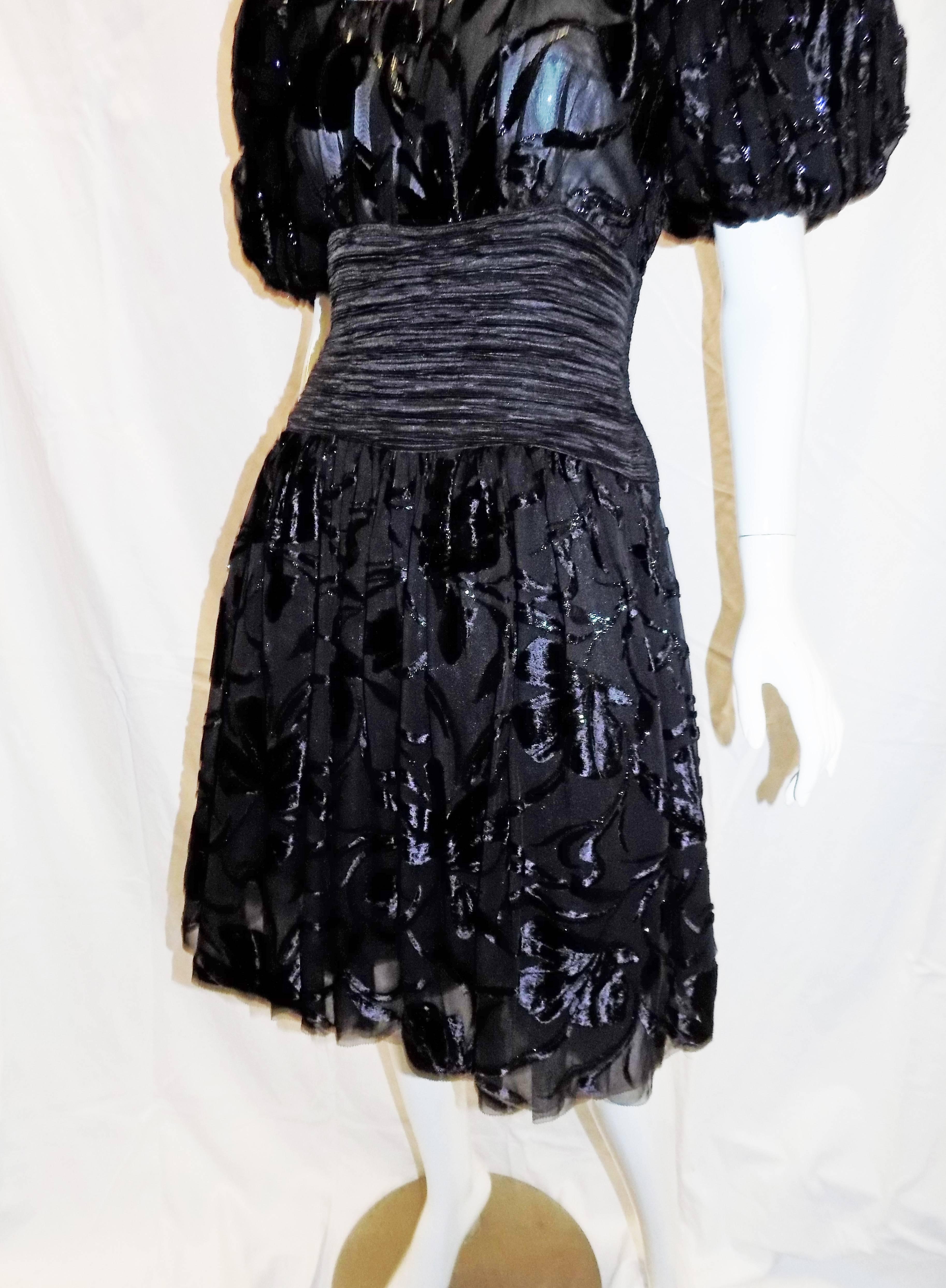 Very pretty  1980's  Mary McFadden  vintage black laser cut velvet cocktail dress. Pristine condition without any signs of aging of wear. Pleated waist line with laser cut  velvet on silk. Puffed sleeves. Full skirt and modest neckline. Very 