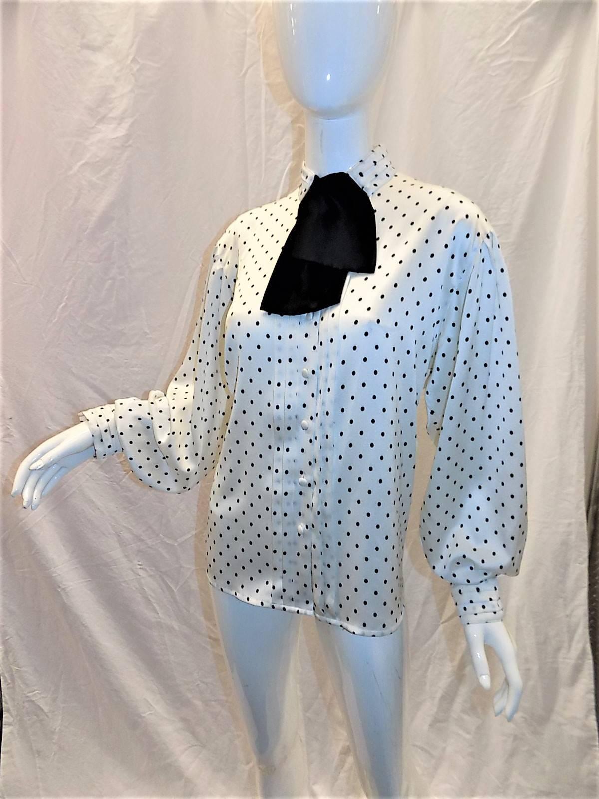 This is a must have vintage Louis Feraud black and white polka dot blouse. Black  neck tie that could be  worn with a pin as shown on the photo or just tied. Perfect office piece. Very elegant wide sleeves, Front button down with folded pleats and