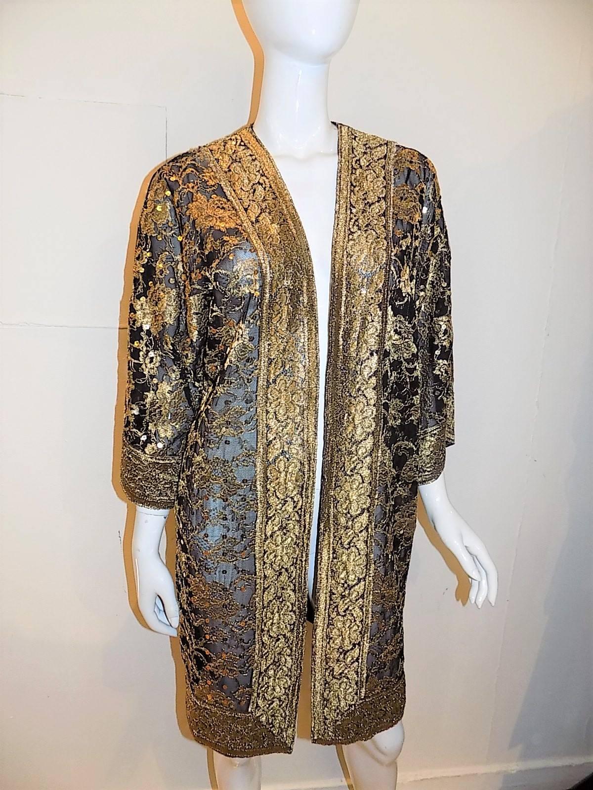 Spectacular Nolan Miller Couture Black and Gold Lace  long Evening Jacket / Coat. Delicate see trough lace with wide gold lace trim.  Entire coat is delicately  covered with gold sequence. Pristine condition. Like new. No signs of any Wear. Marked