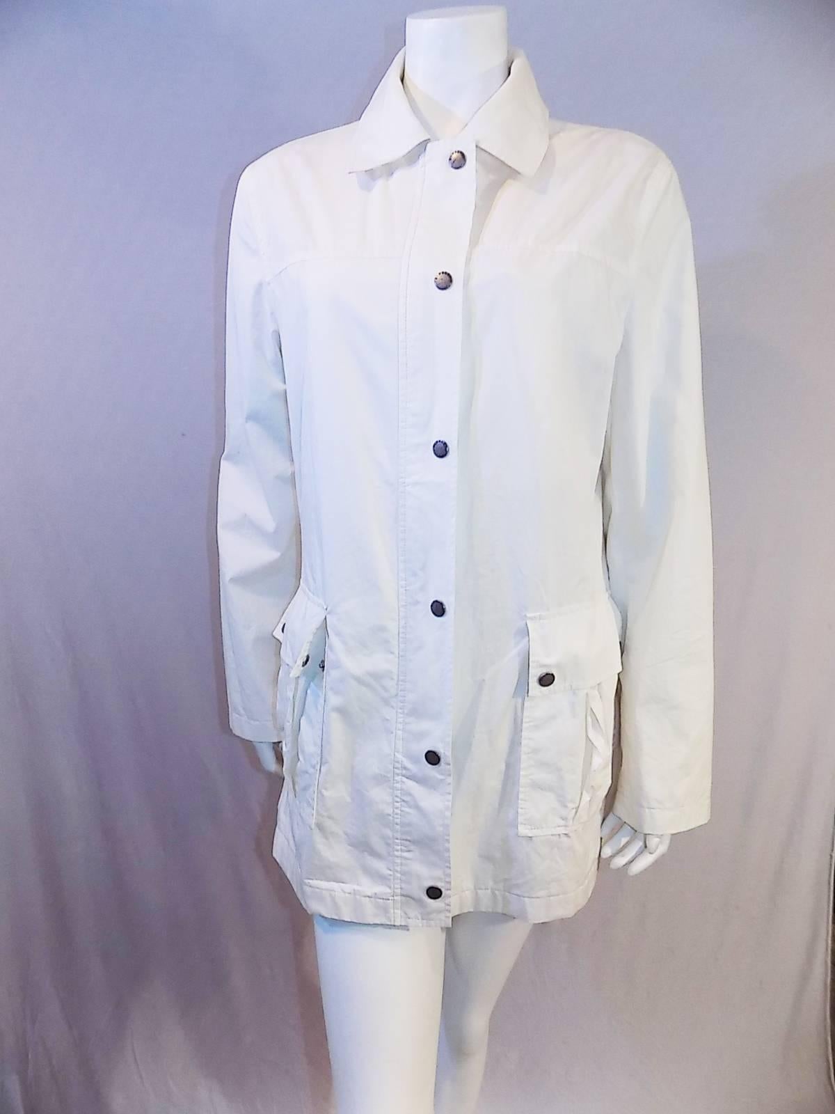 Fabulous white Burberry rain jacket with pink novacheck lining. Excellent condition! Outer coat is 100% cotton with Poly lining . Concealed zipper front closure featuring Burberry logo engraved on the zipper pull. Zipper flap over with logo snaps.