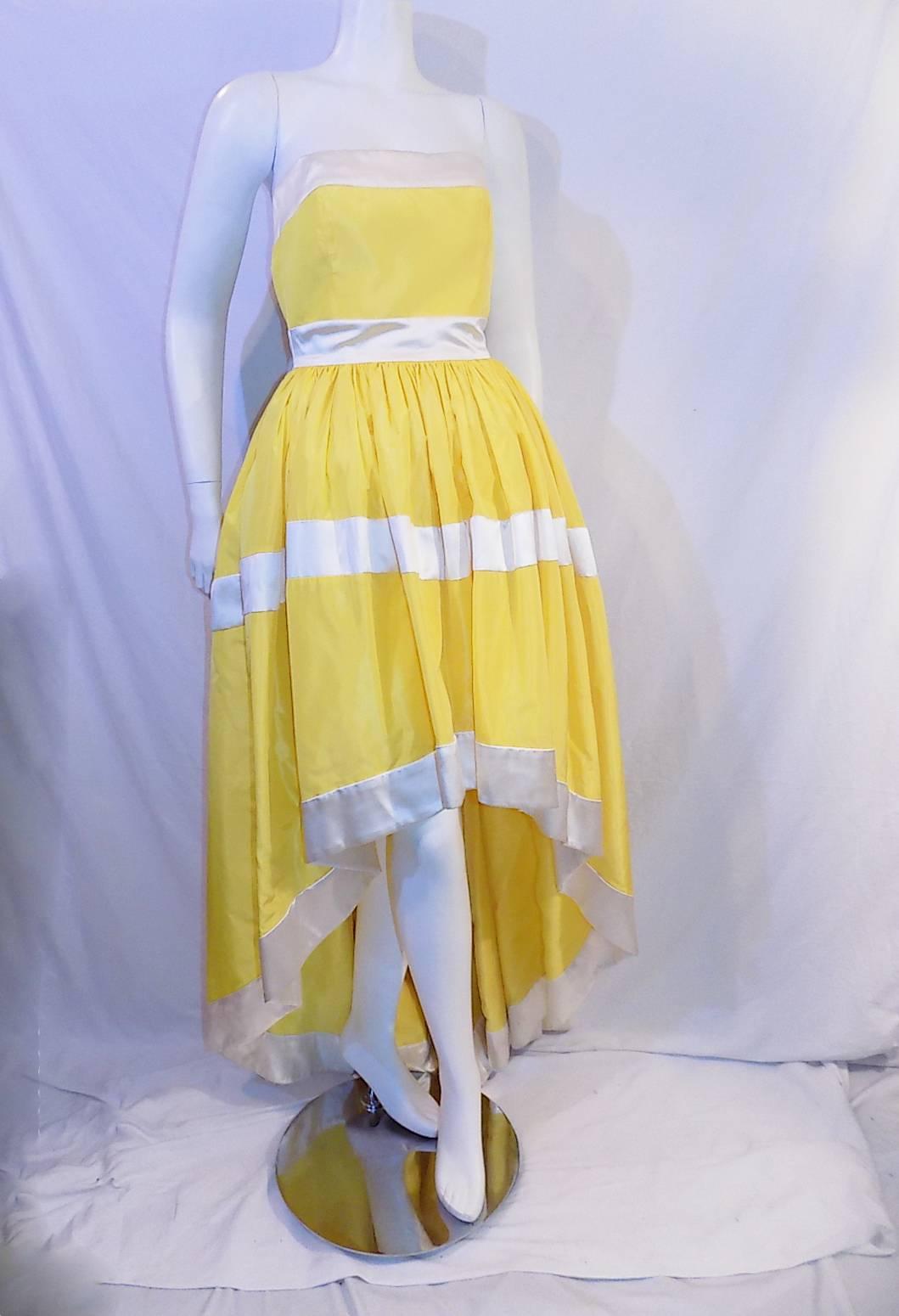 Pristine condition without any signs of wear! Yellow silk taffeta with wide white satin trim. High /low skirt style . Corset bodice. Dress features 3 bows at the back that could be removed if you like. Size  states 38 but   it is size 6 US.