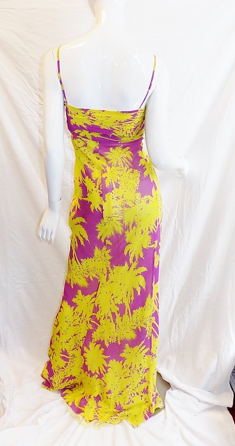 Perfect summer dress for resorts! New with tags. Silk chiffon  in purple and yellow palm print. Front adorned in rows of iridescent large palliates. Great for day with flat sandals or for hot summer night.Made in Italy.100% silk
Italian size 40.