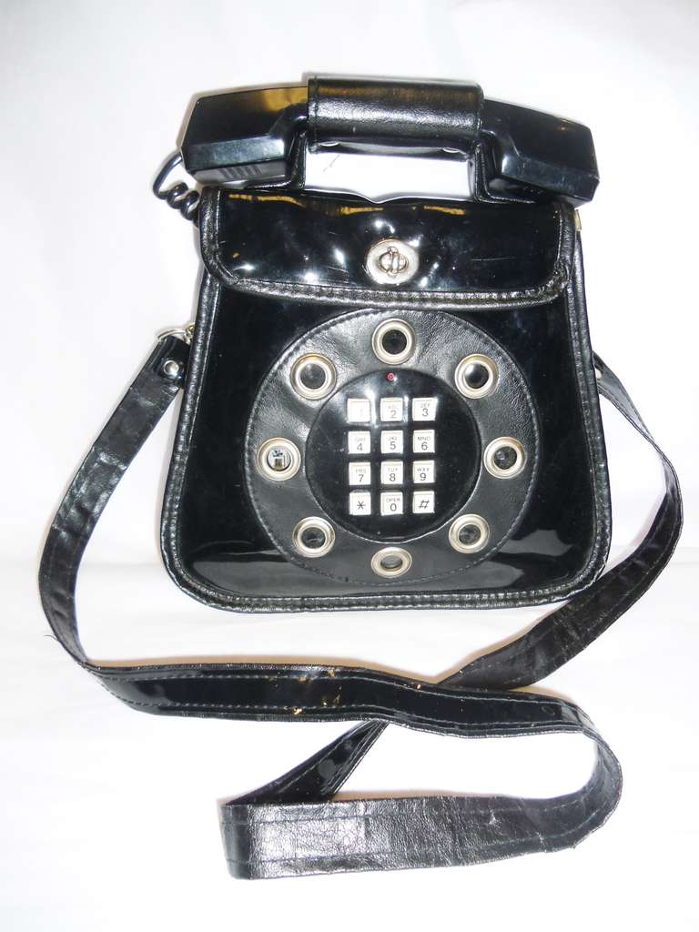 Here's rare 70's telephone purse -- in which the phone actually works. (In case you don't know Jack, or don't remember when phones were plugged in things, you'll need access to a phone jack to make this old bag phone work.). Still with original tag.