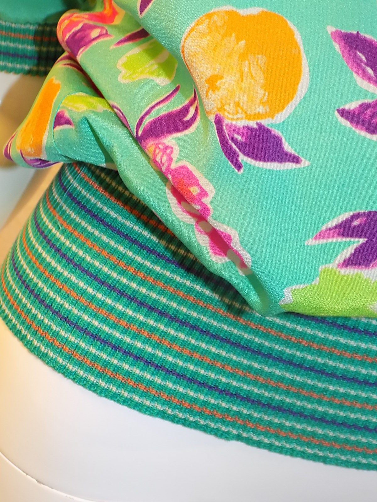 Emanuel Ungaro aqua  green multicolor floral bouquet silk twill short-sleeve top.
 Lightweight silk twill.  Boatneckline. Waist and sleeves  trimmed in matching striped rib-knit.    Button and loop closure at back. 
    Made in Italy.Excellent