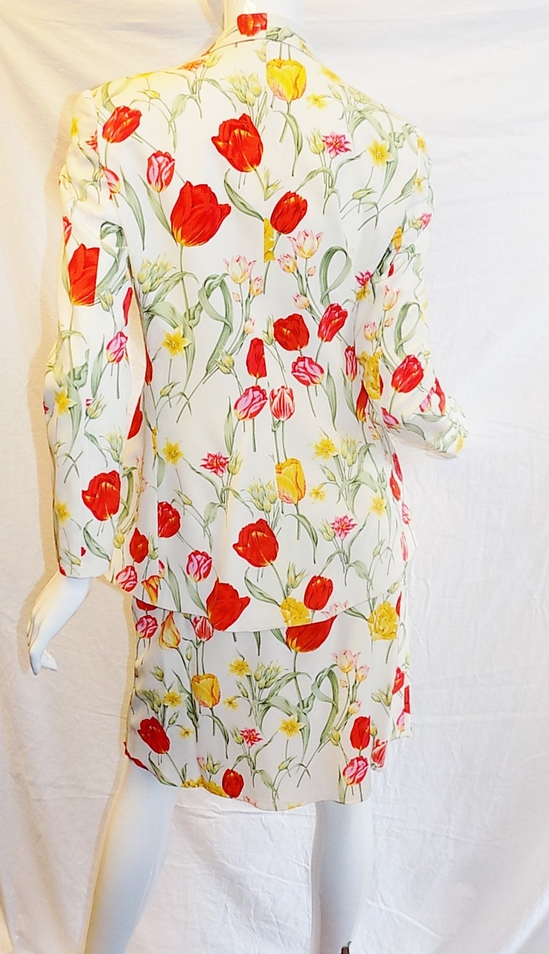 Spectacular Valentino's ( Miss V line)  floral garden skirt suit. In pristine condition vivid colors almost come alive flowers . Jacket features shawl collar , two pockets and two mother of the pearl front button closure. Slight a line skirt 