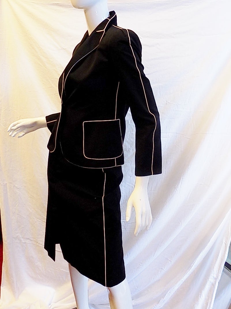 SUMMER SALE!! Black polished cotton with ivory piping. In excellent condition!! Early Marc Jacobs!! So beautify styled, cut and tailored. Silk lining. Jacket features two front patch pockets. one button front closure. Skirt has front and back open