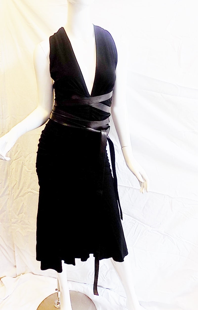 Spectacular Donna Karan Vintage halter  black cocktail dress.  Black jersey Featuring  rushing in the middle back and front  and  soft leather long  belts that wrap around the body any way you like. Pristine condition!! no sign of any wear.  As most
