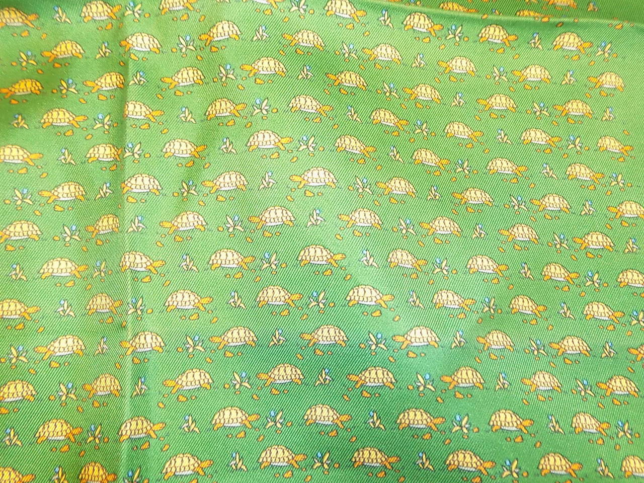 Beautiful color , crisp silk, plump edges and  spectacular print. Green background, small  turtles  and tiny blue forget me not flowers .
Never used in pristine condition. 16 