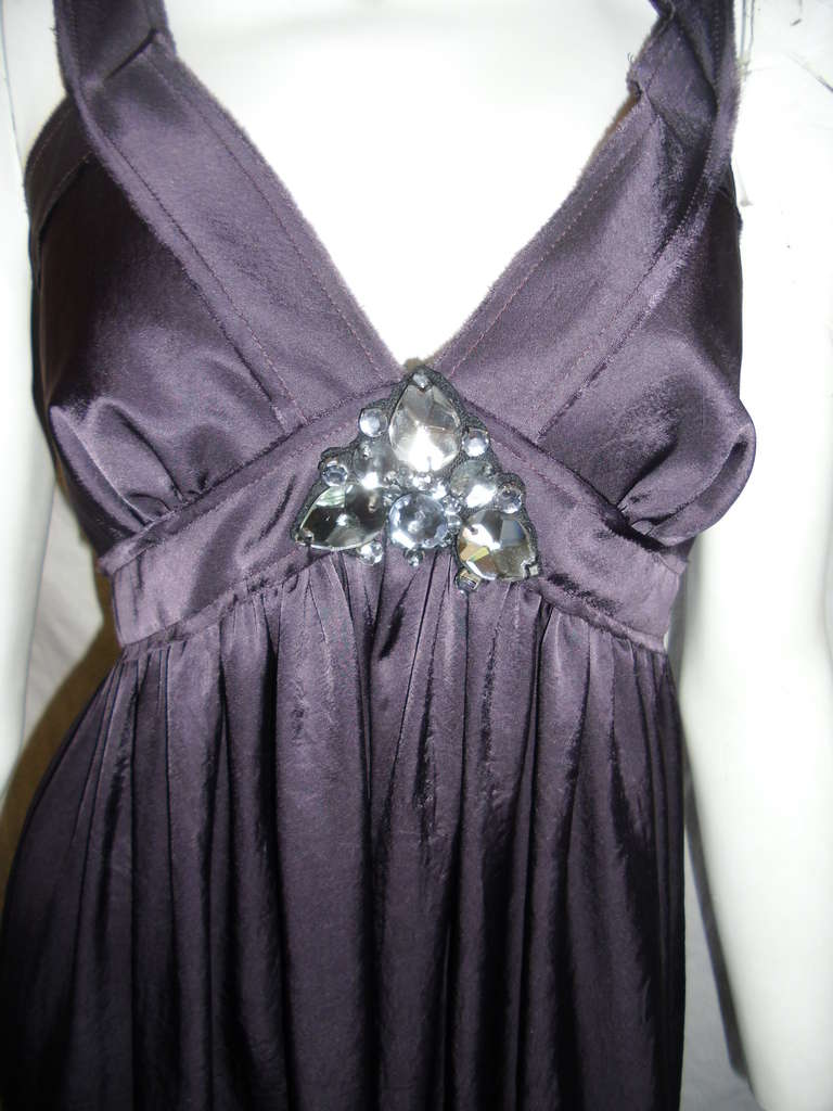 Beautiful eggplant purple color.  Never worn in pristine condition.  Crystal detail at the front. Concealed side zipper . Size 40
Bust 38