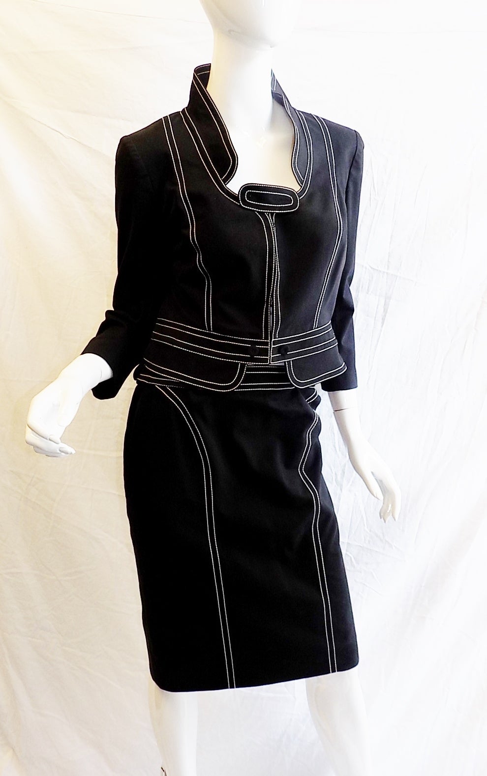Barely worn in absolutely mint condition!! 
Sublime Givenchy Vintage Black Cotton skirt suit with White stitching . Cotton poplin lining. Hook and Eye front concealed closure. Incredible details and design! 
95% cotton, 5% elastine
Size
