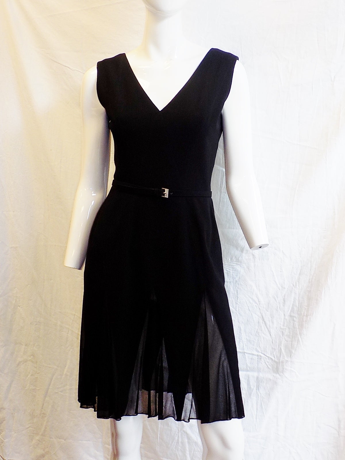 Simple and elegant Chanel Haute Couture Black wool gorgette dress. Dress is featuring asymmetrical row of covered small buttons at the side of the back along the zipper line,V neckline, black chiffon inserts in skirt part and two belts. One with