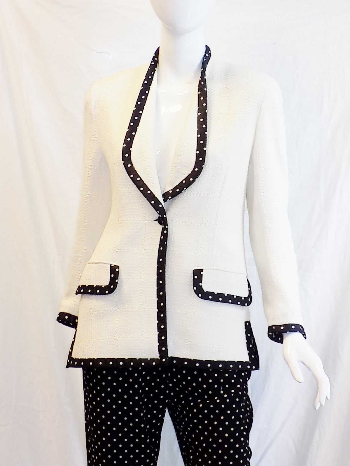 Perfect  for spring and summer and very chic! White  on white  raw silk ecru and black and white polkadot crepe silk  pants. Matching trim on the jacket.  Enamel painted buttons. Pristine condition. 
States size 12 but very small 12
Please refer