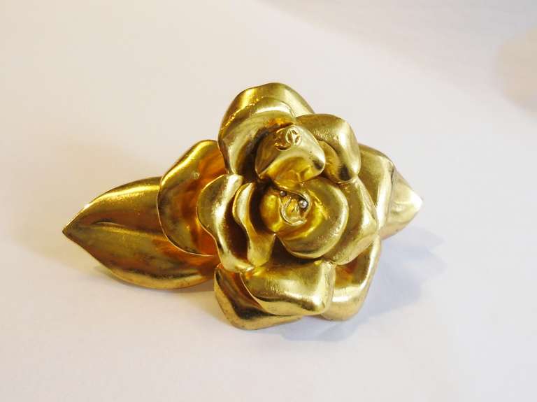 Stunning brass Camellia barrette by Chanel.. Very rare to find. Stamped 99P. comes with original box, pouch ans original tag. It is approx 3.5