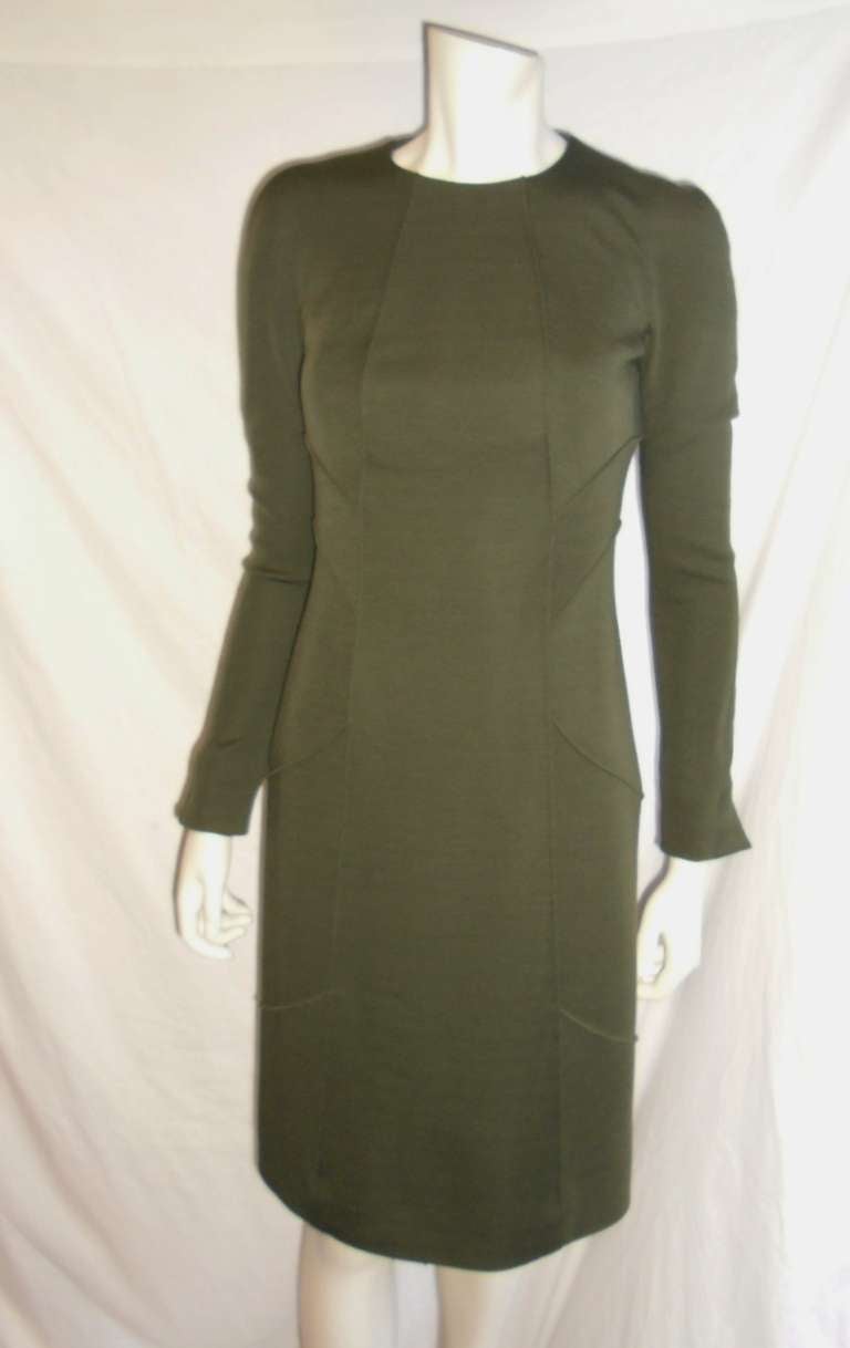 Great fall dress. Fabulous for work. 100% will jersey. Pristine condition. Pinched stitch on the sides for perfect silhouette . . Jeweled neckline. Size  4
Bust 34