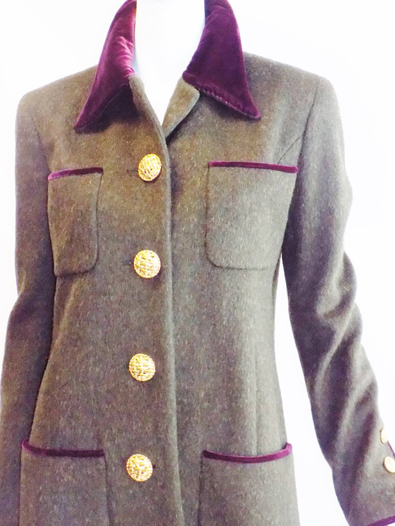 Looks like it has never been worn! Tailored to a perfection. Moss green color with plum silk velvet collar and trimming.  I believe that it is wool and mohair blend. Very large front buttons closure. Back vent. Fully lined silk with cc logo. Size
